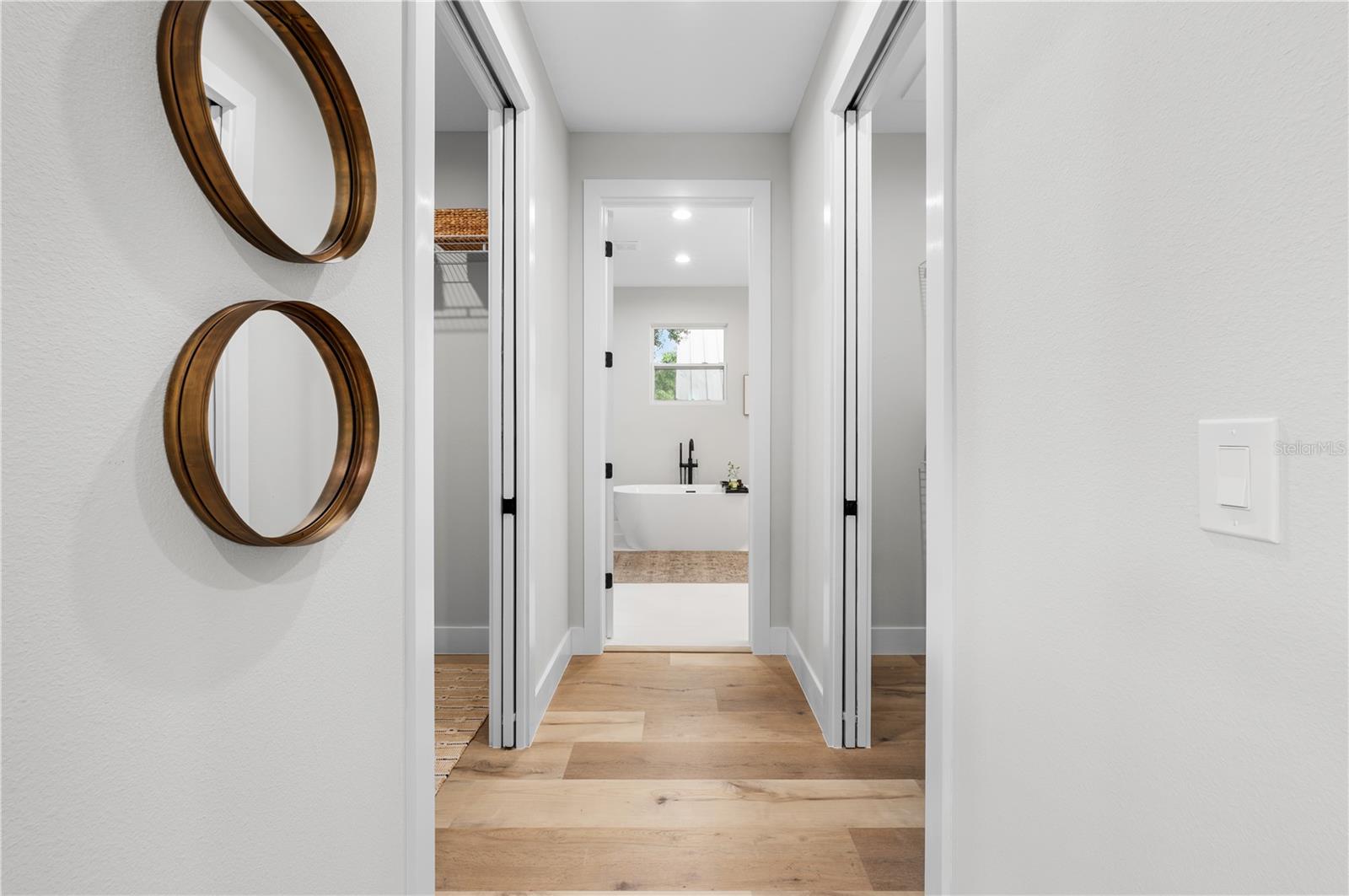 Entrance to the dual walk-in closets and spa-like primary bathroom