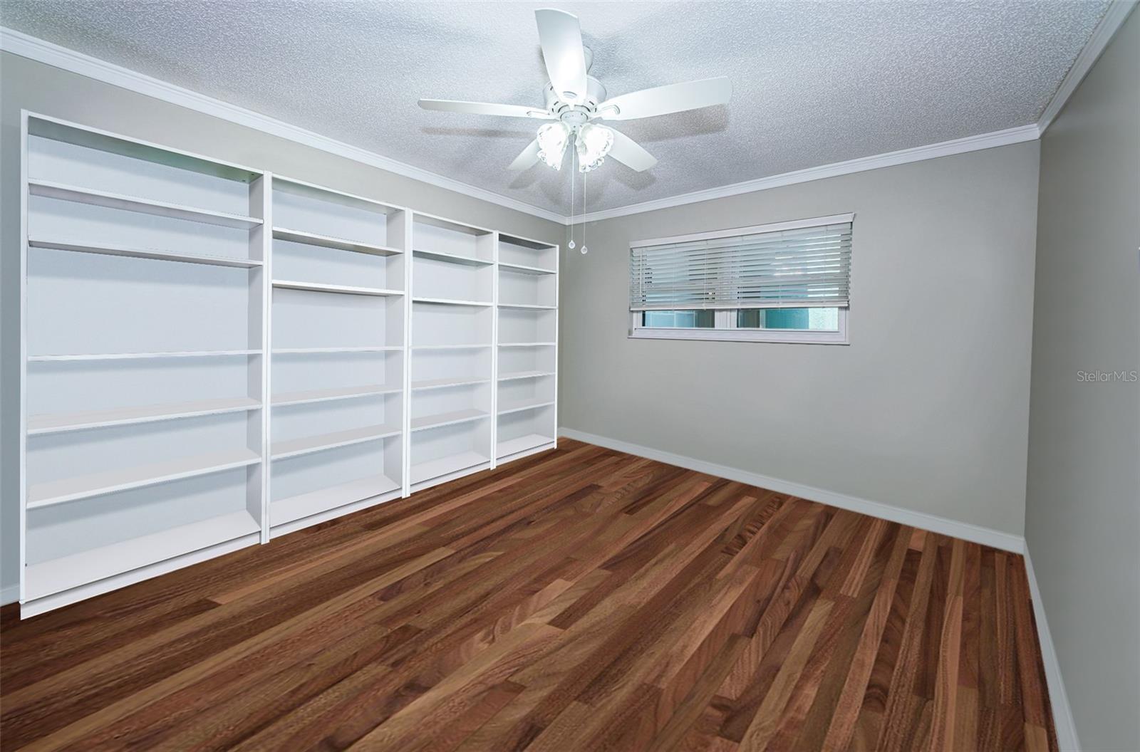 Bedroom #2 has been used as a craft room. Shelves stay with the home.