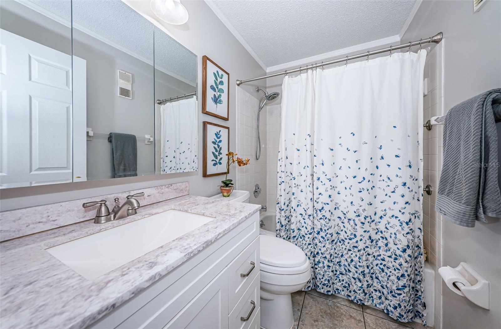 Hall bath with a bathtub is next to bedroom 2.