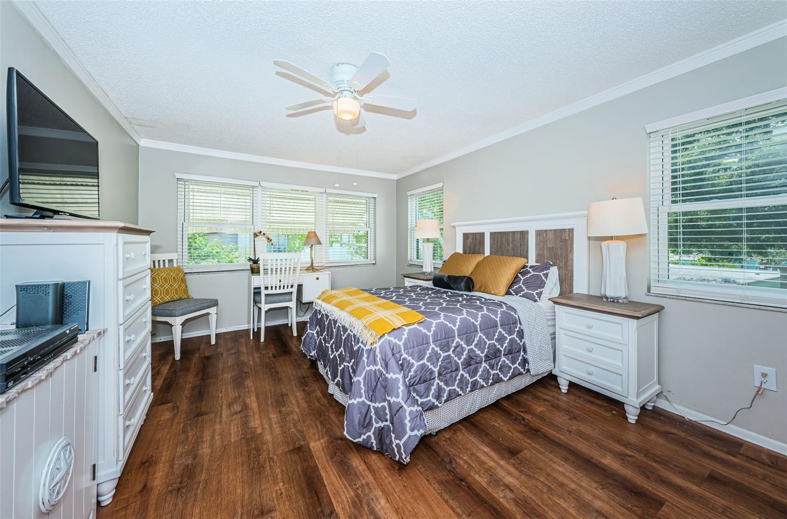 The primary bedroom is light and bright with views of the water.