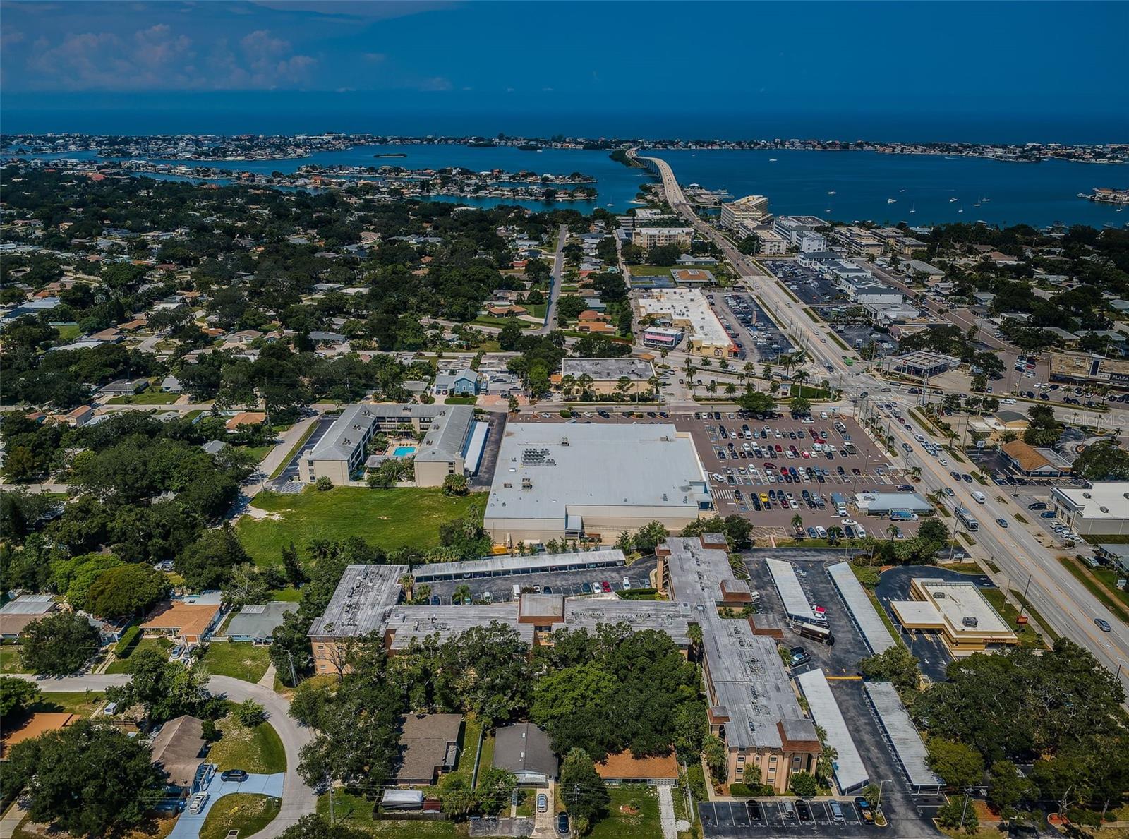 Aerial view showing the condo building and the surrounding area, highlighting its convenient location and nearby amenities.