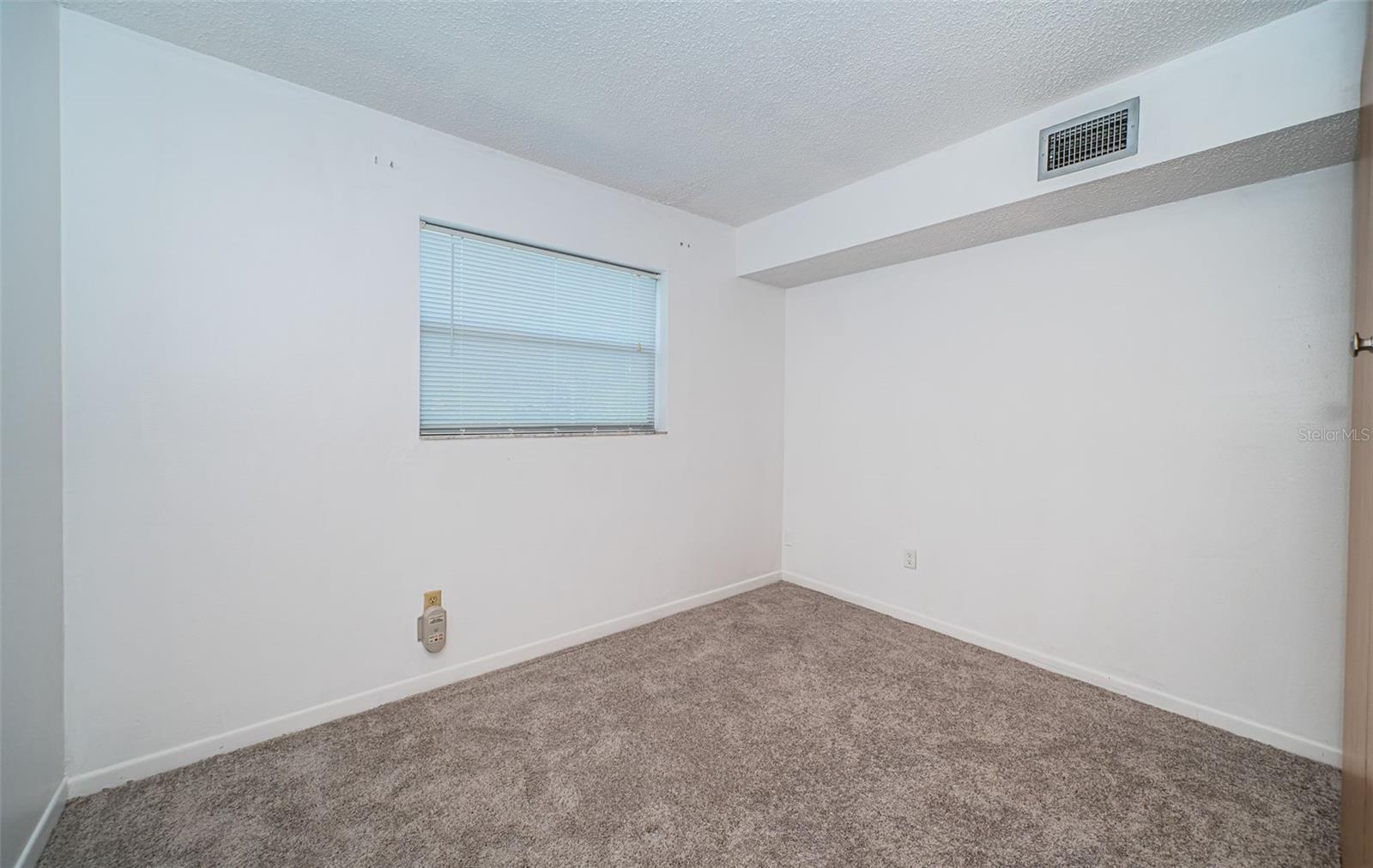 An empty master bedroom, offering a spacious and inviting area that you can transform into your own personal sanctuary.