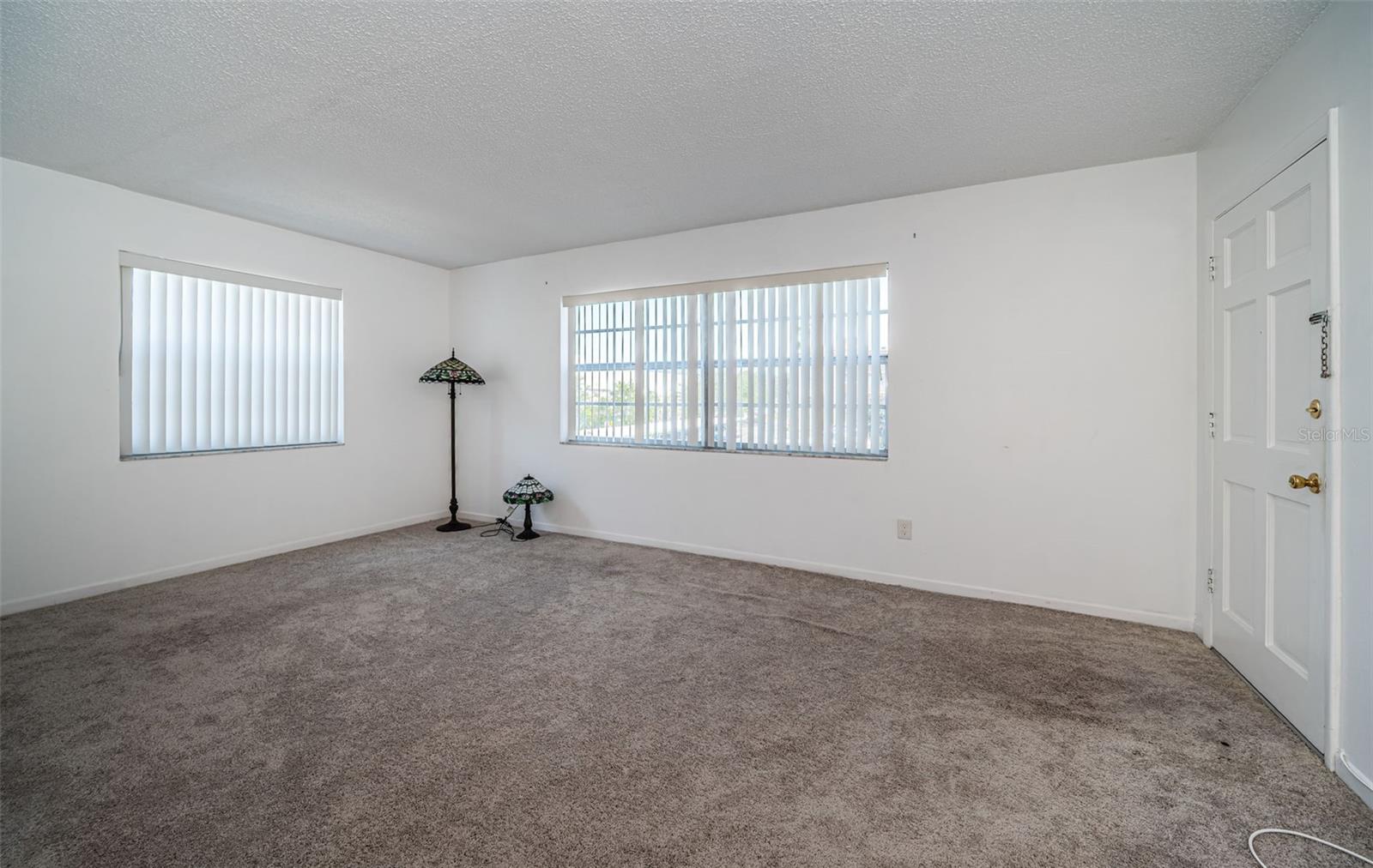 An empty living room offering ample space and a neutral backdrop, perfect for customizing with your choice of furniture and decor.