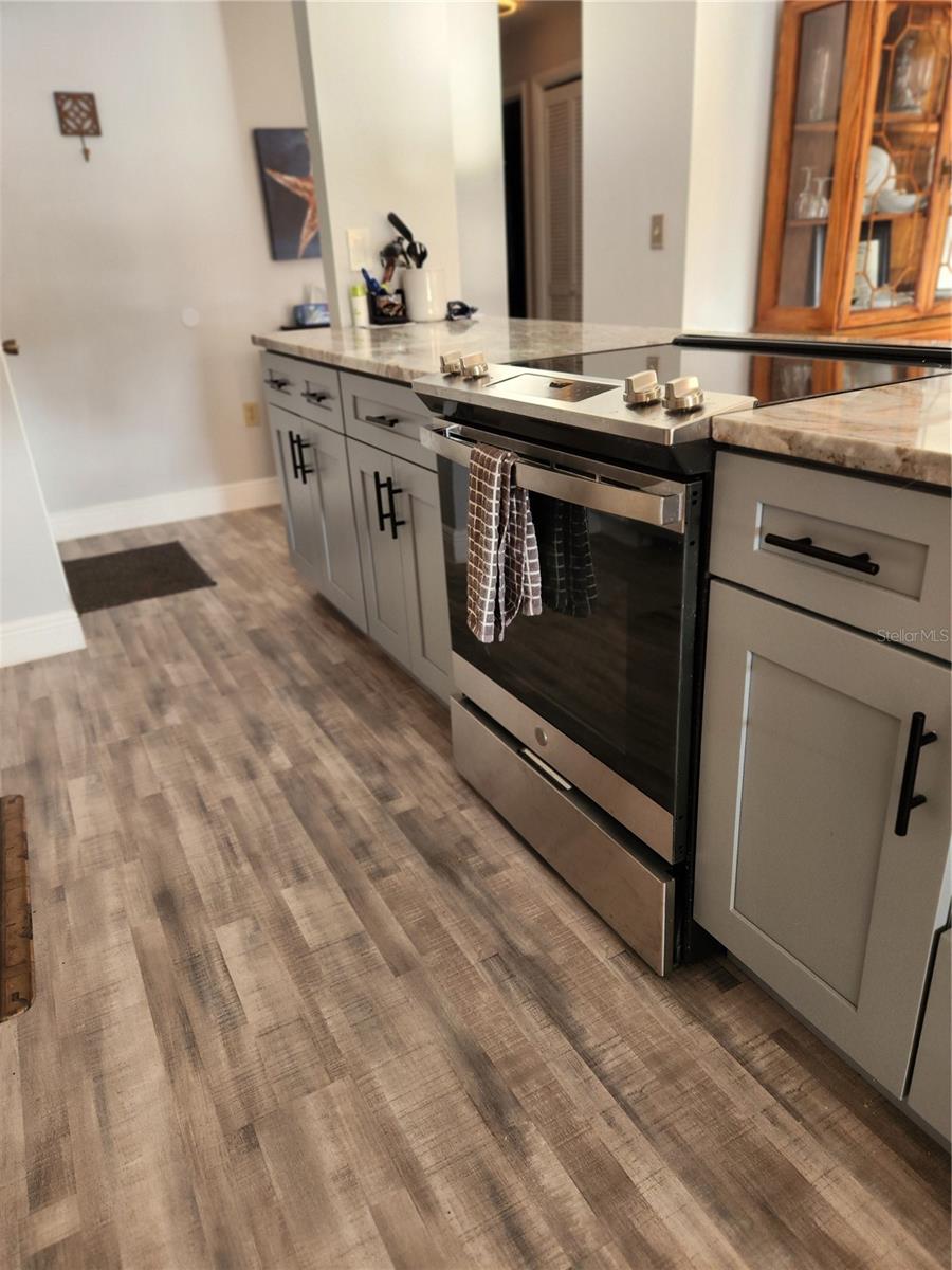 Two tone kitchen cabinets. Vinyl plank flooring