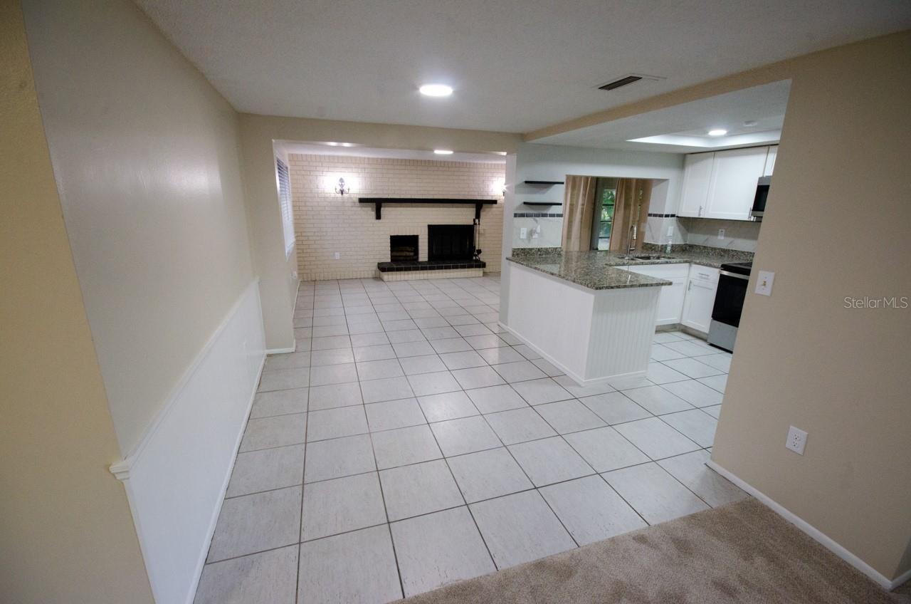 LOOKING FROM THE FRONT ROOM TO THE KITCHEN AND FAMILY ROOM