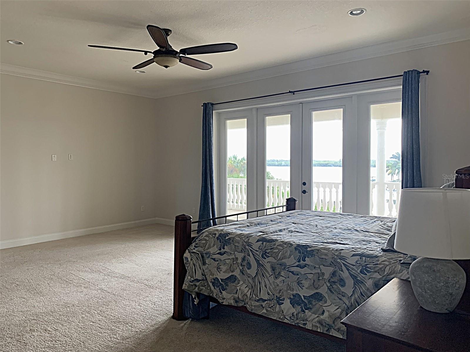 Primary bedroom with balcony and outstanding water views