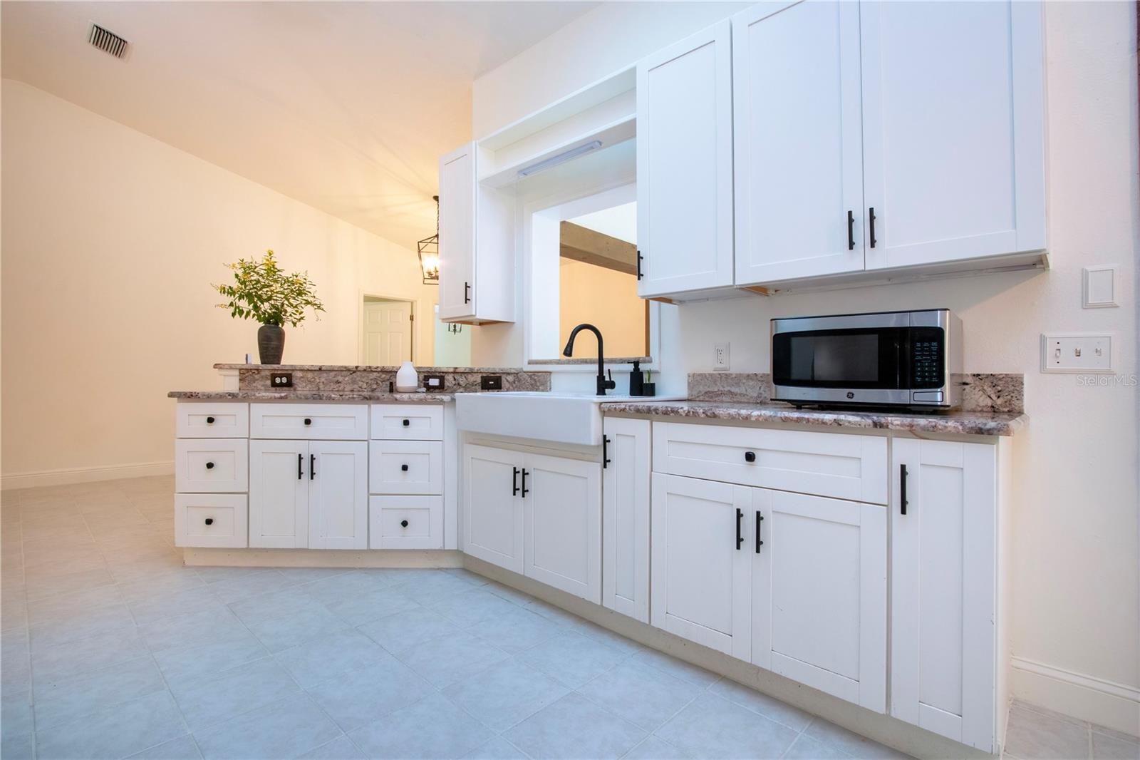 Updated kitchen with granite counters new microwave and fresh cut flowers from the food forest