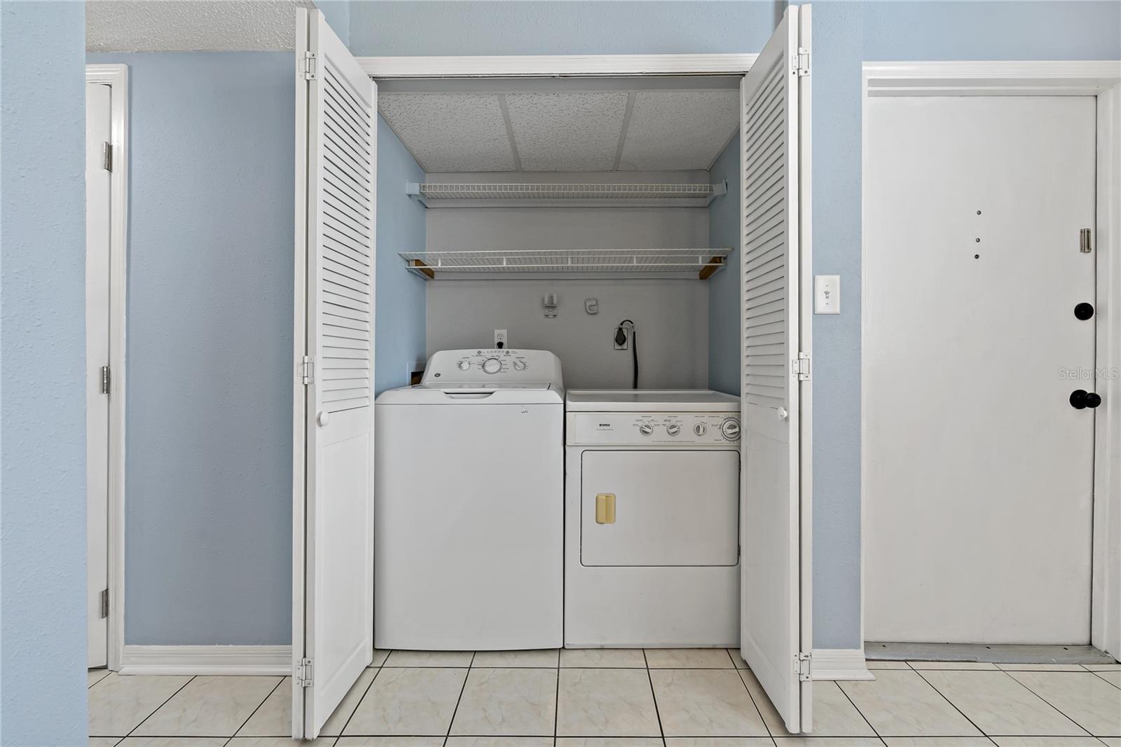 Full-size Washer/Dryer in Utility closet with shelving