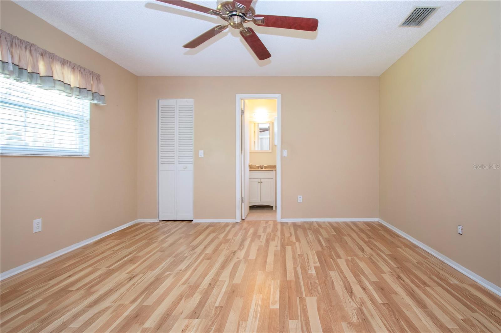 Owners suite view to updated bathroom and walk in closet