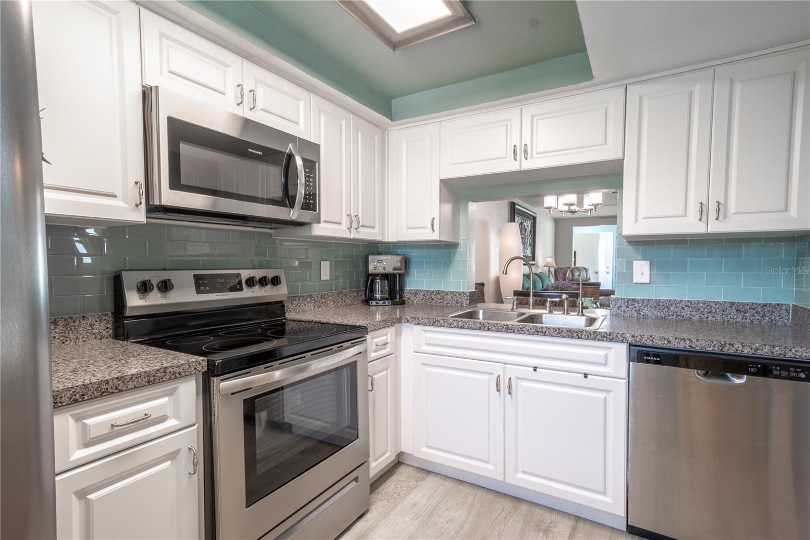 The kitchen features a double basin stainless steel sink with a convenient pass-through to the dining room.