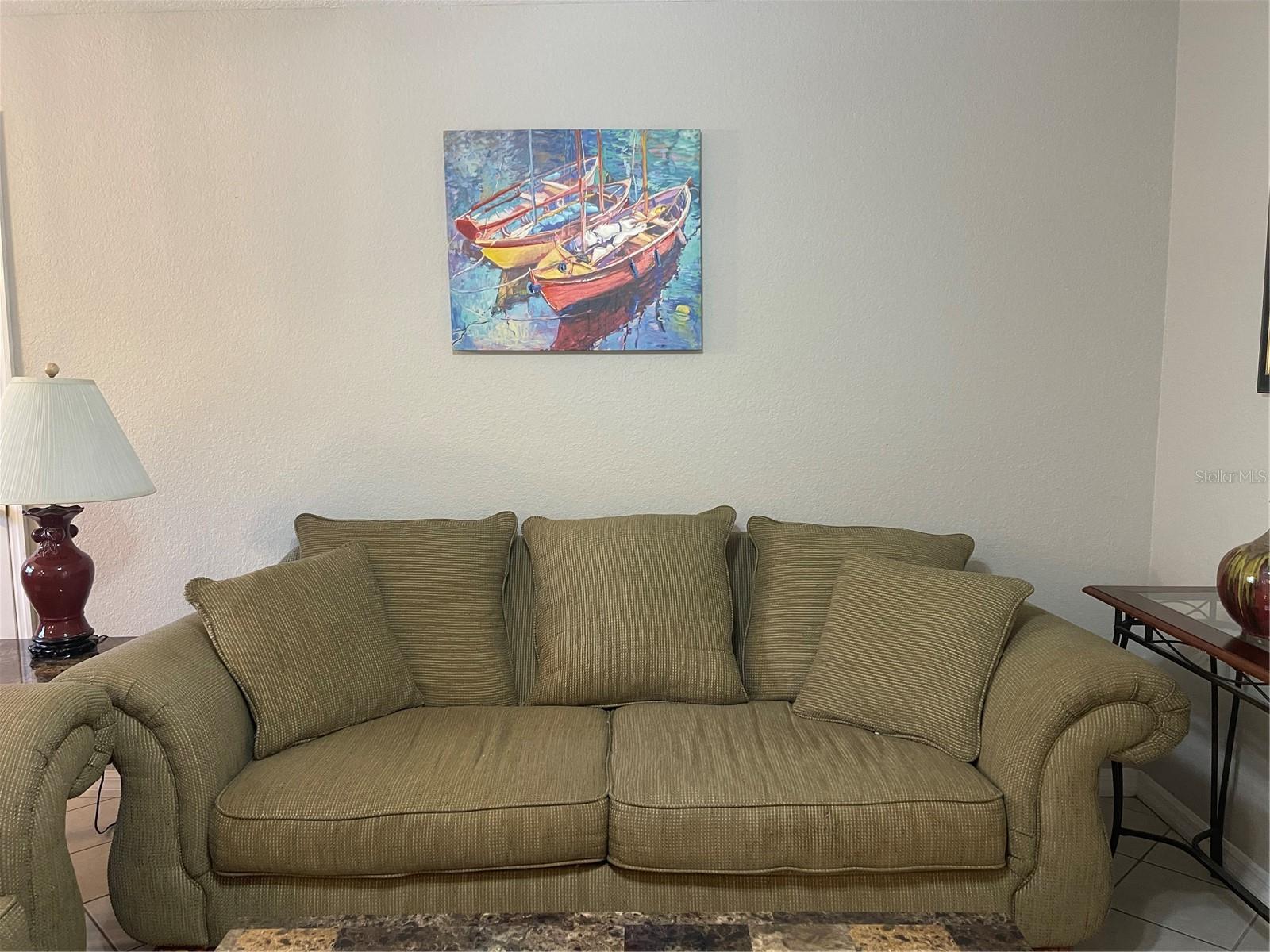 Couch and art will convey with the condo