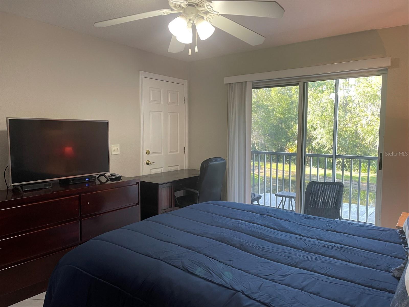 Door behind desk leads to dining room and living room of main side of condo.