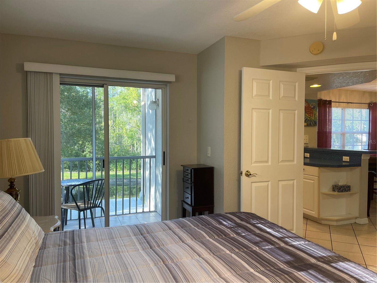 Sliding glass doors in primary bedroom exit out to private balcony.