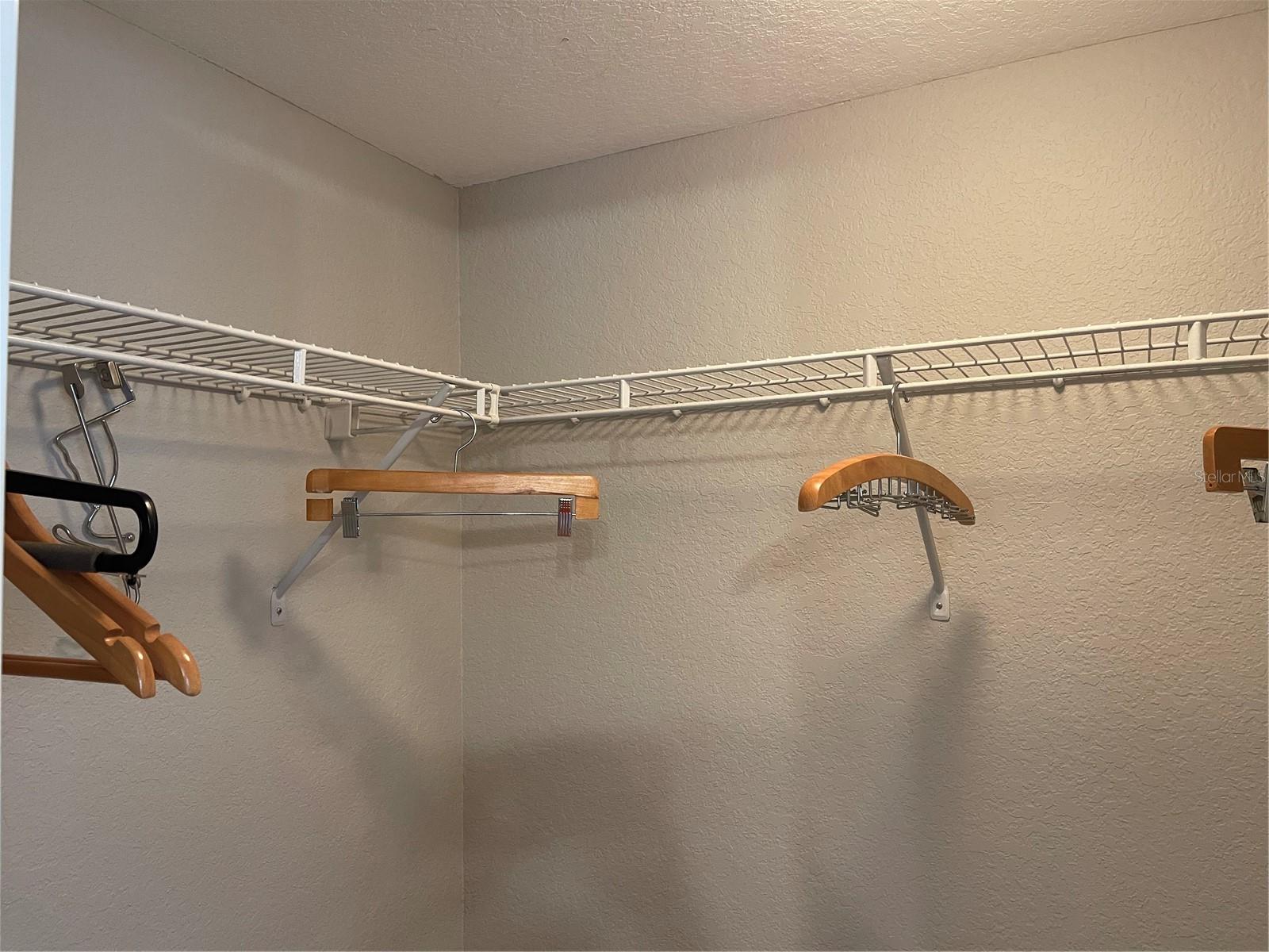 Walk in closet has shelves