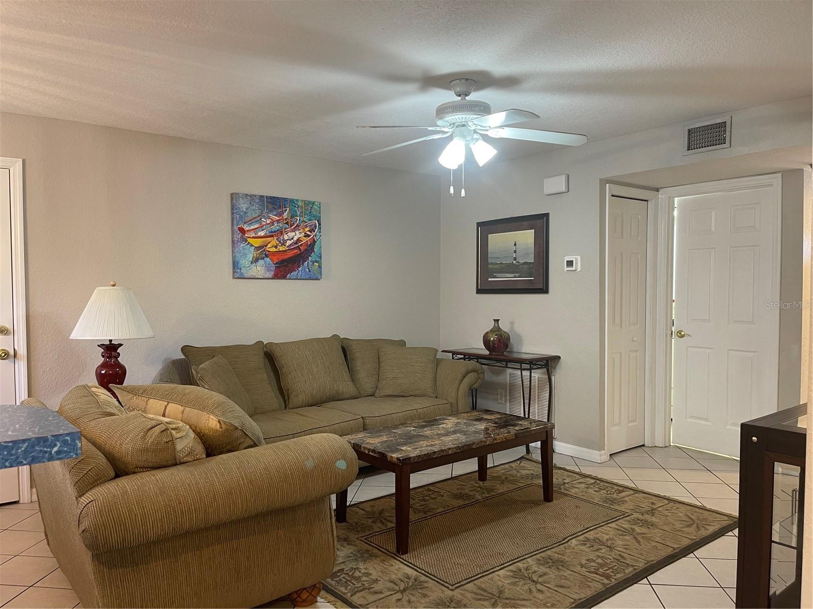 Living room furniture and rug will stay with the condo