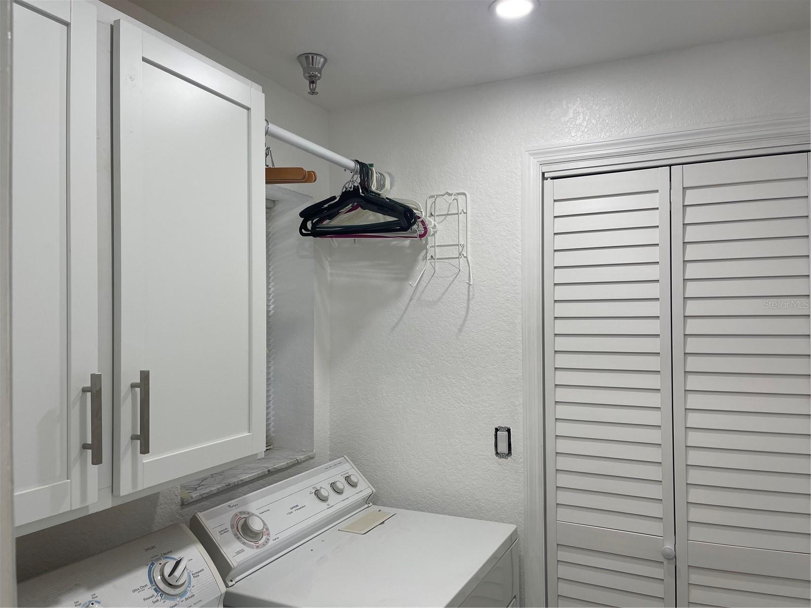 Laundry room cabinet and and clothing bar installed in February of 2024