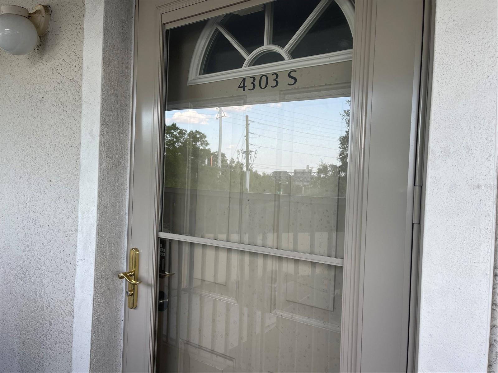 Storm door with roll screen studio entrance installed February of 2024