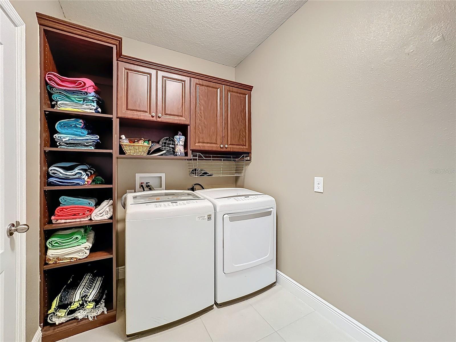 Large Walk-in laundry room. Custom Built-in cabinets