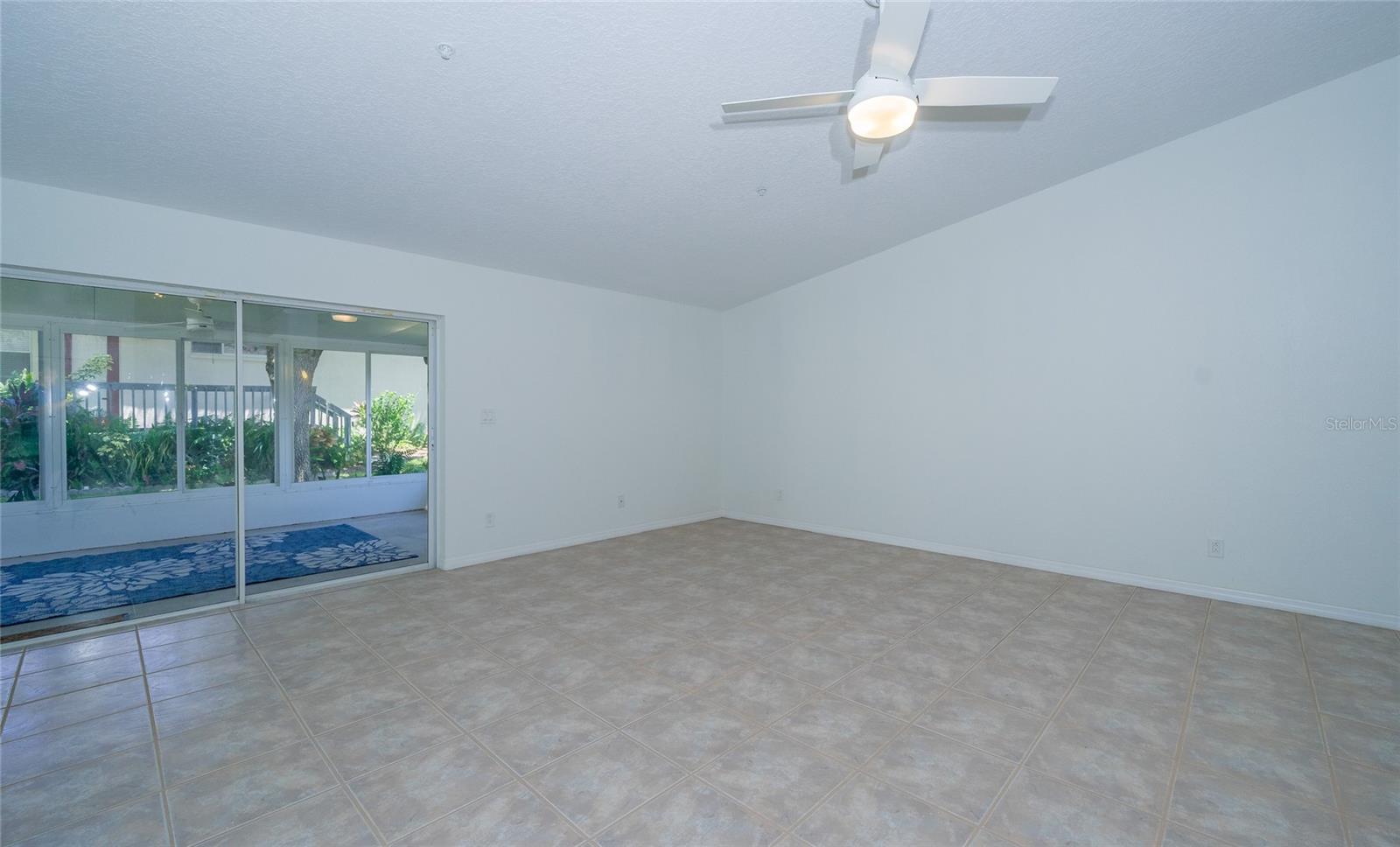 great room with sliders opening to screened porch