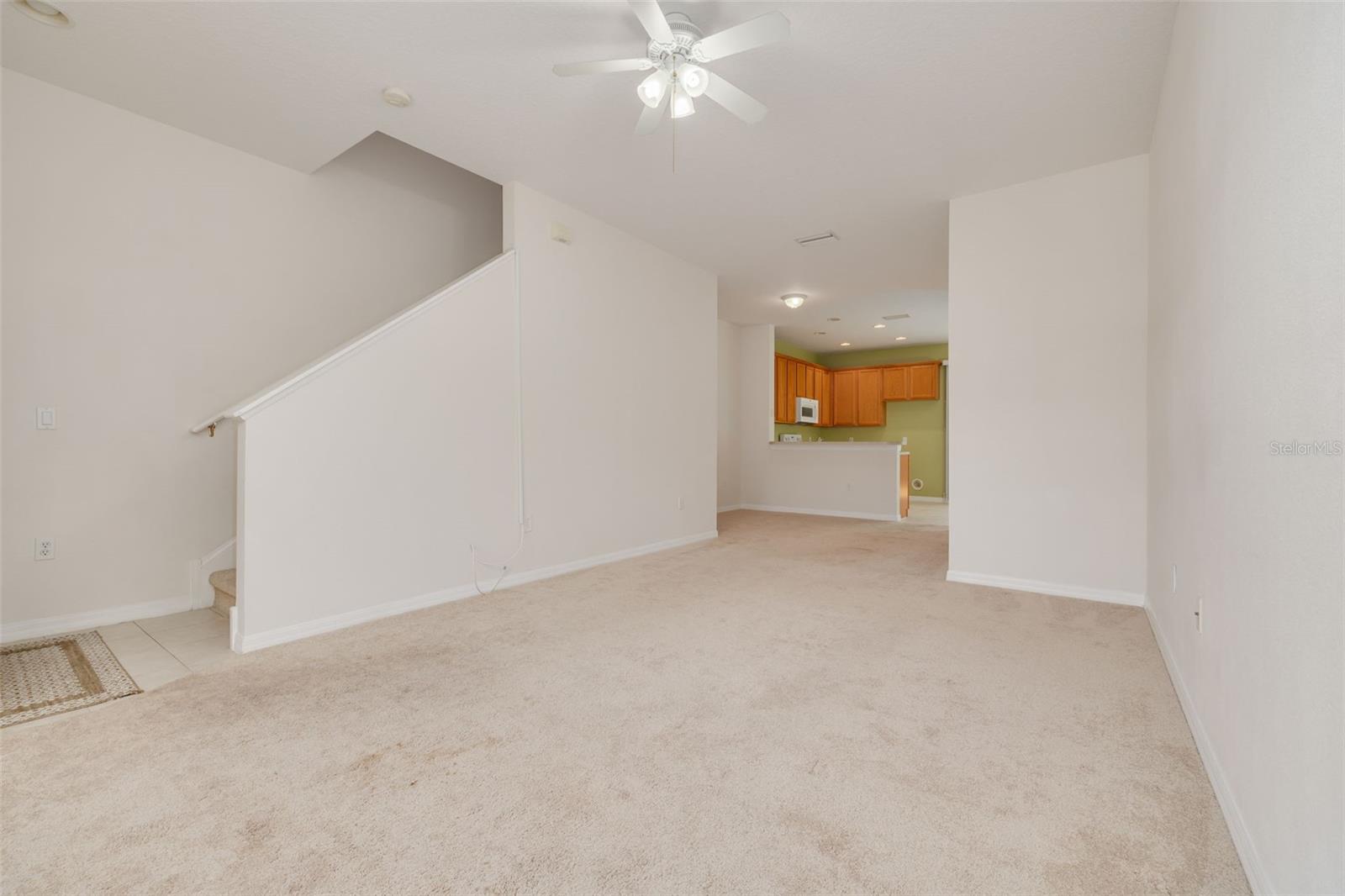 Living Room with Stairwell Leading to 2nd Floor