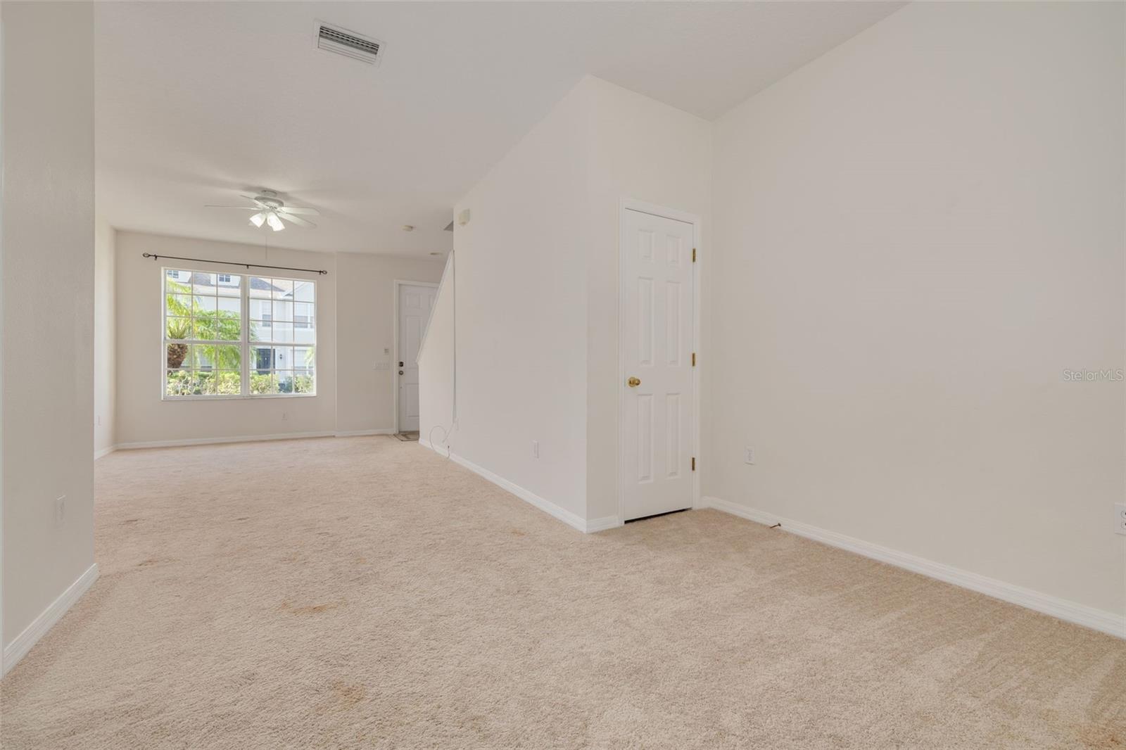 Dining Room Area with Closet Storage under Stairs