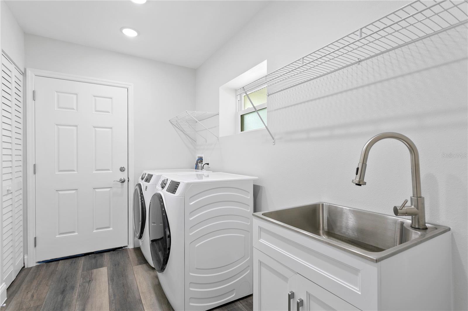 Laundry room with GE washer/dryer and easy access to the garage