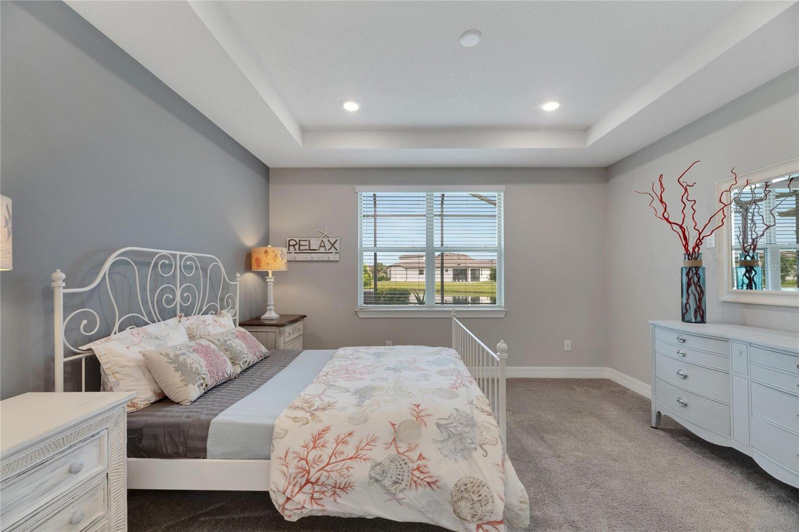 primary bedroom with view of pond