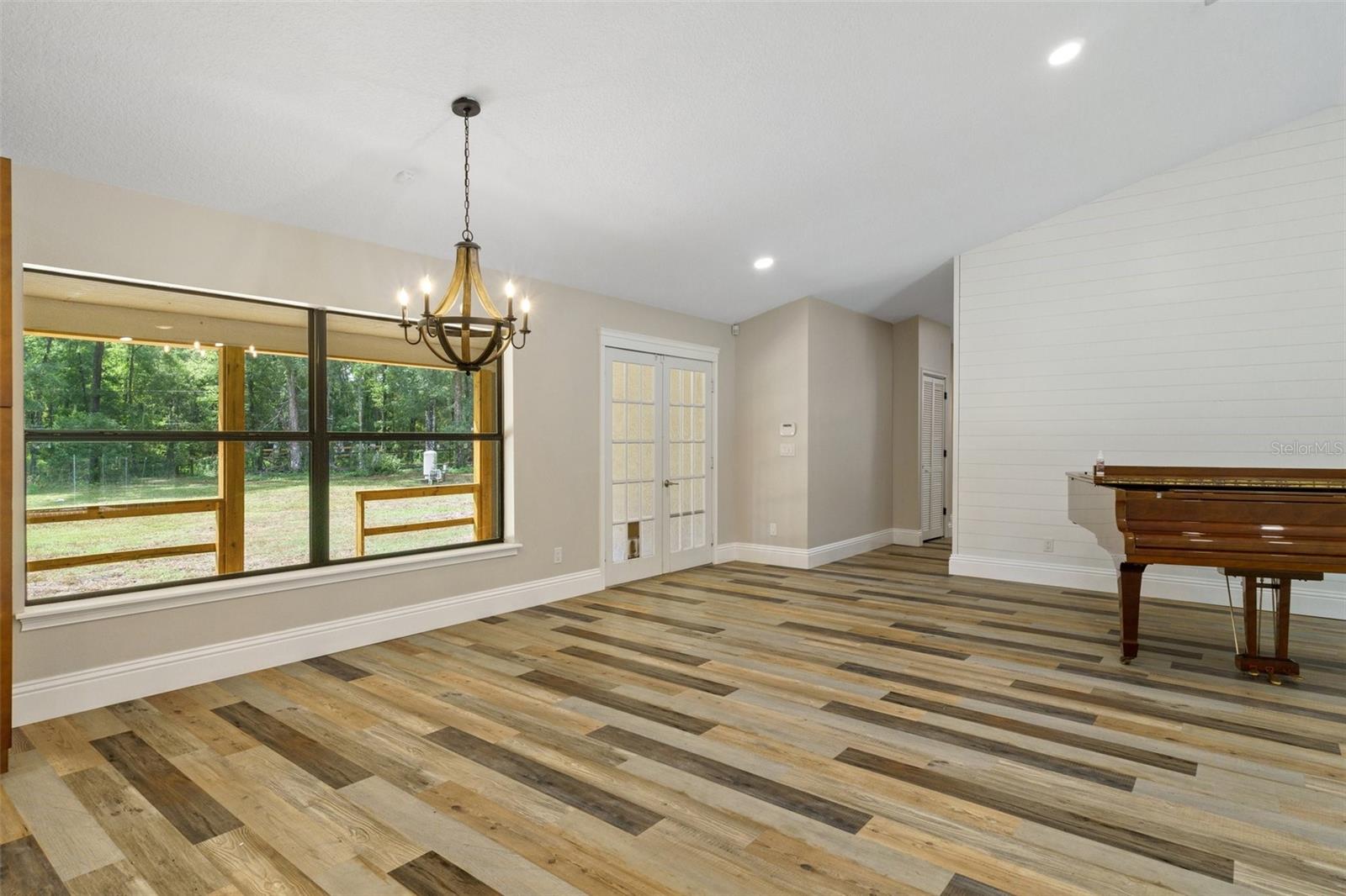 Open hallway leads to bedroom and recreational room.