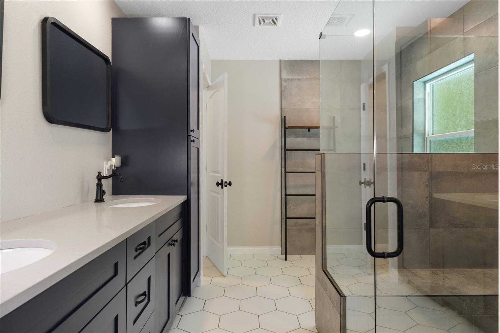 Gorgeous ensuite bath with modern fixtures, spacious walk-in shower, separate soaking tub and water closet.