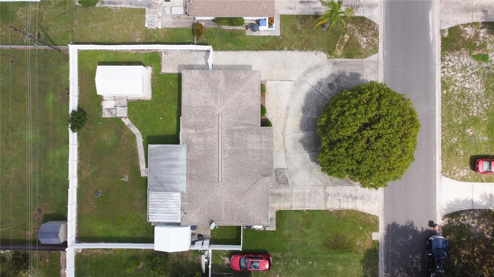 Aerial view showing the large backyard with terrific parking pad and terrific circular drive.