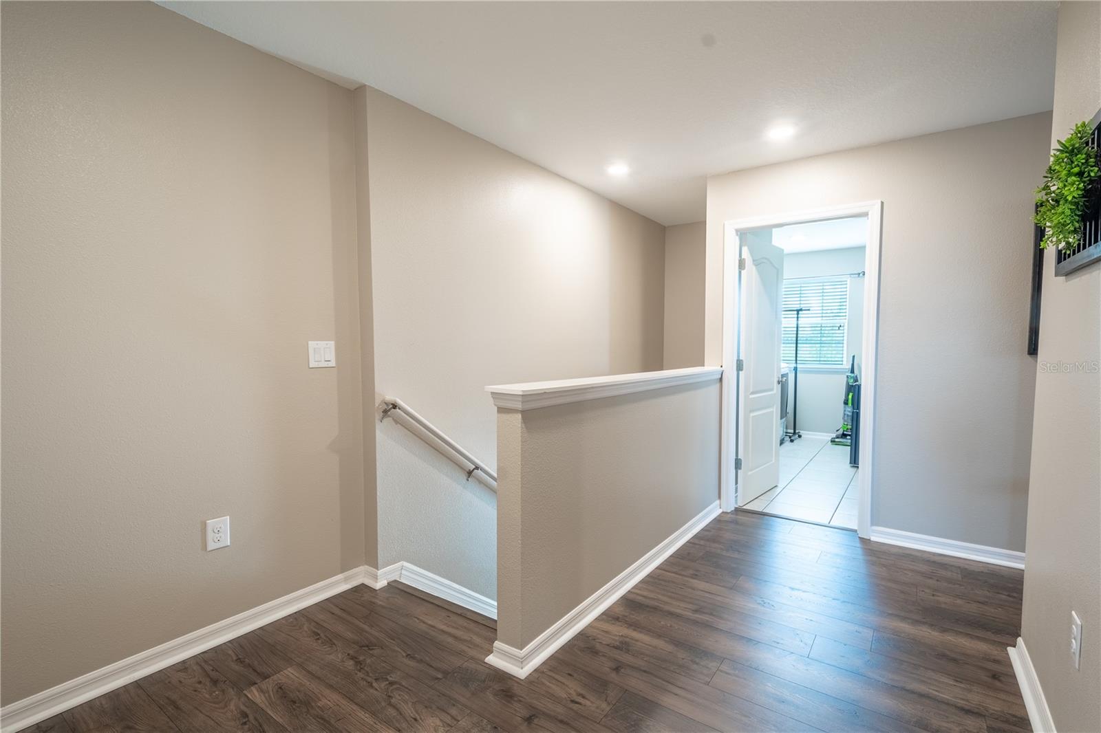 The upstair land features wood laminate flooring.