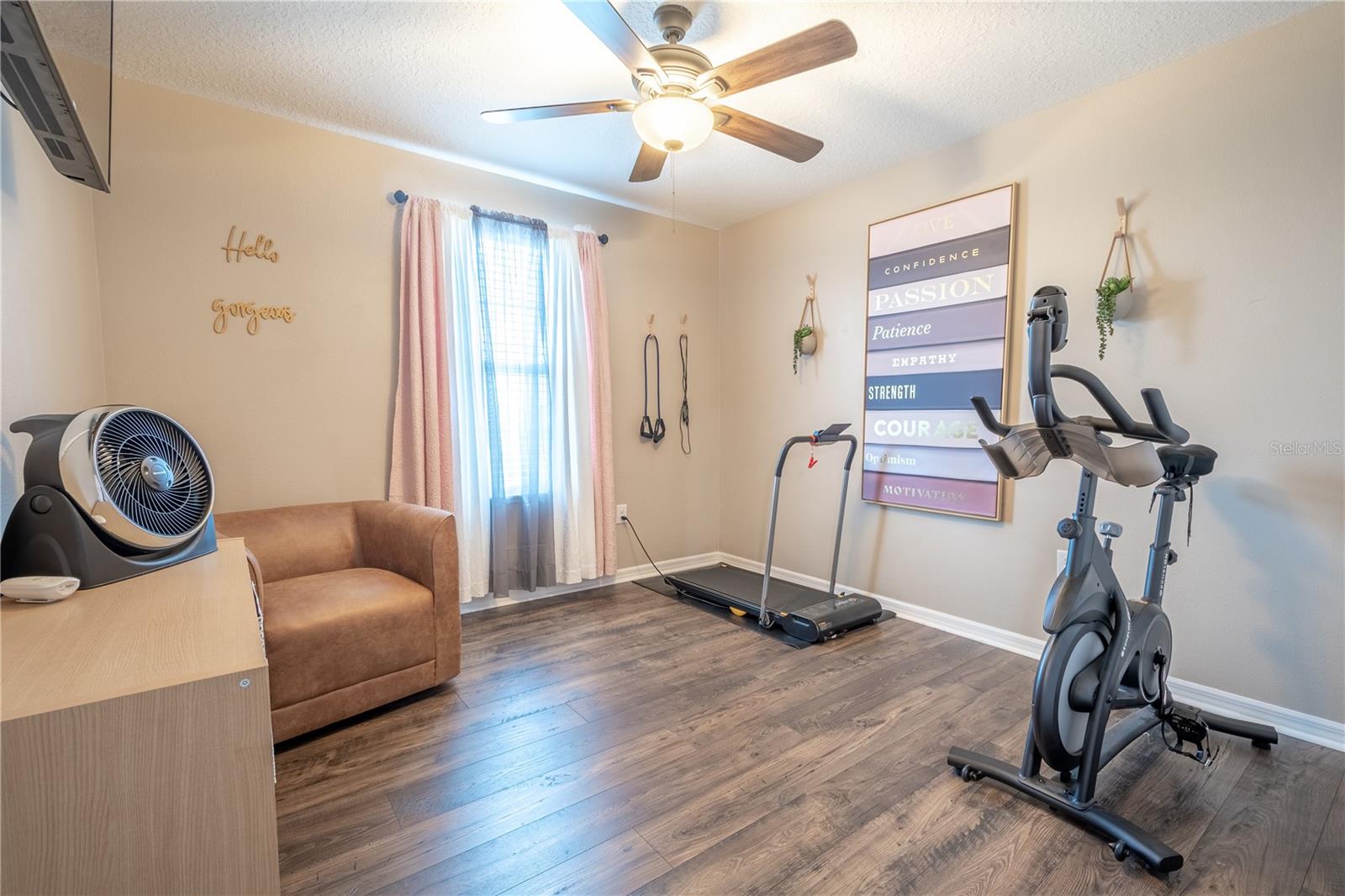 Bedroom Three features wood laminate flooring, a built-in closet and a ceiling fan with light kit.