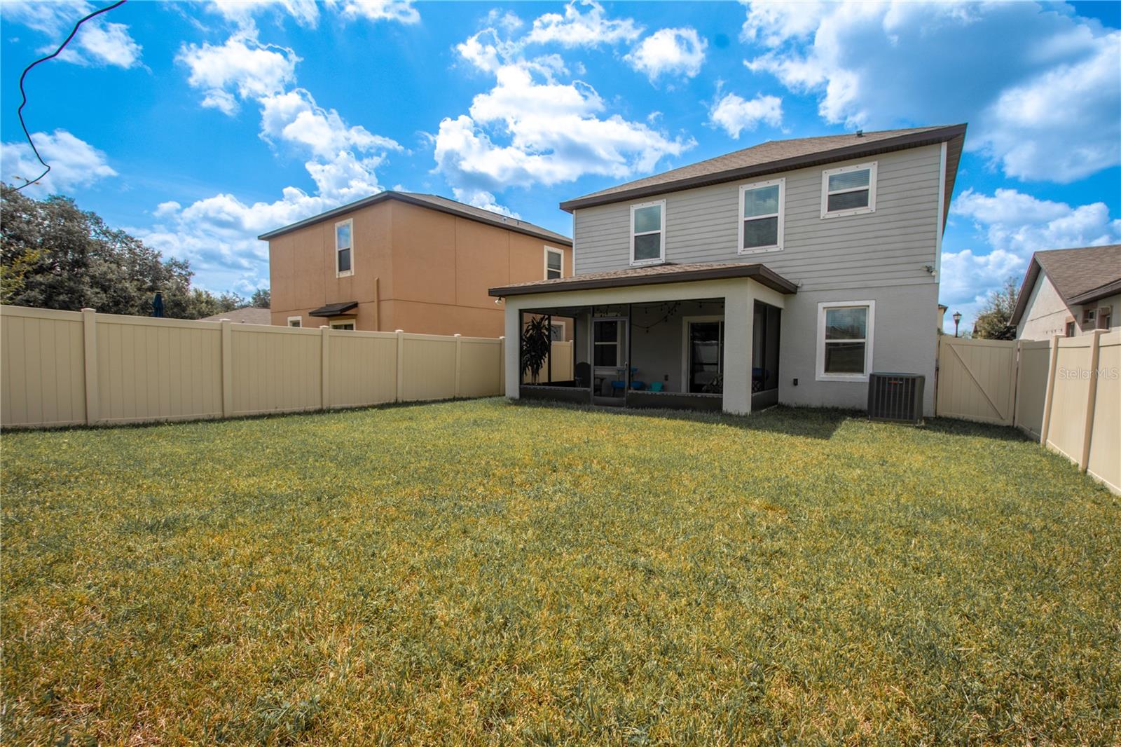 The fenced in backyard is ideal for family and pets to play.