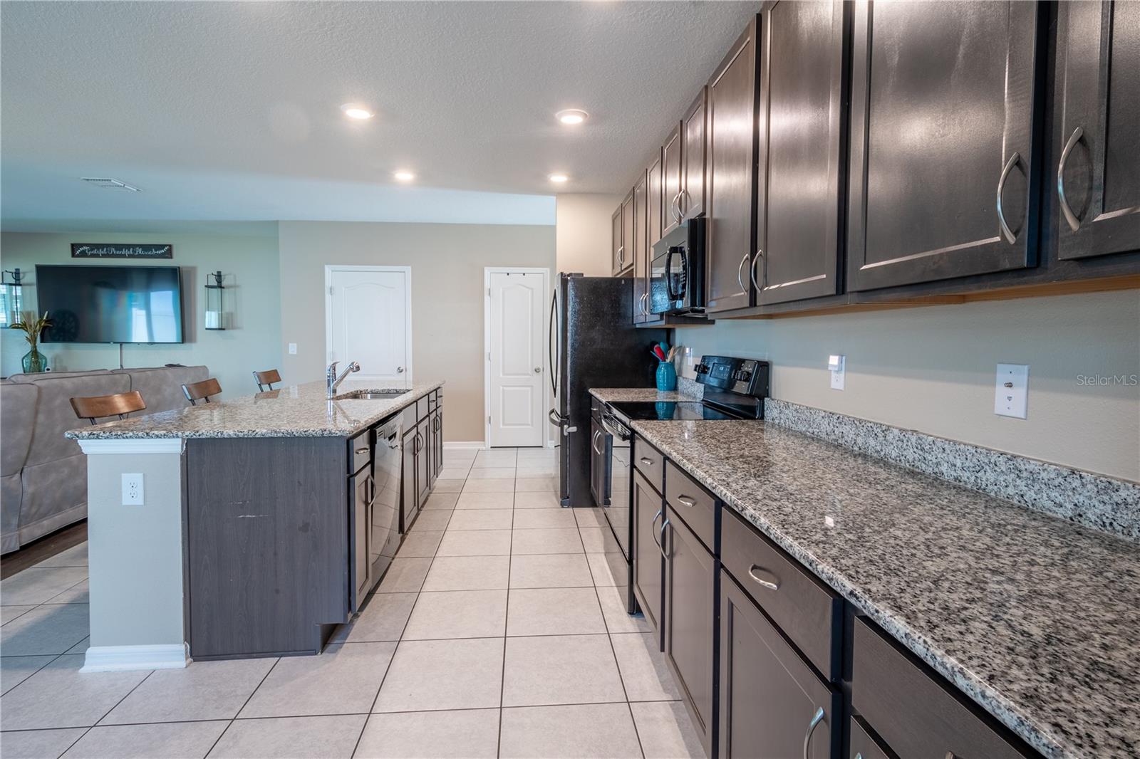 The kitchen features an abundance of counter space, ideal for meal prep.