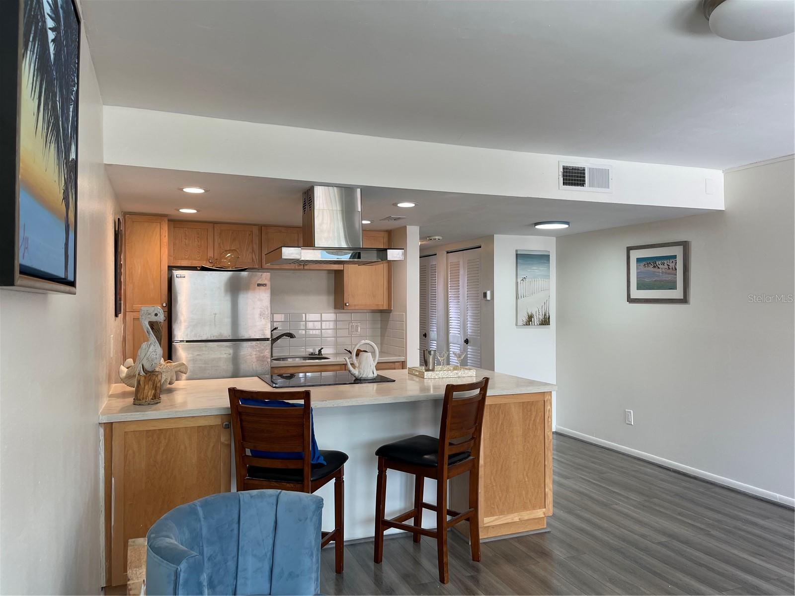 Cabinets were upgraded by the owner. Both wood panels on the Left and right side of the preparation island open up with shelving inside