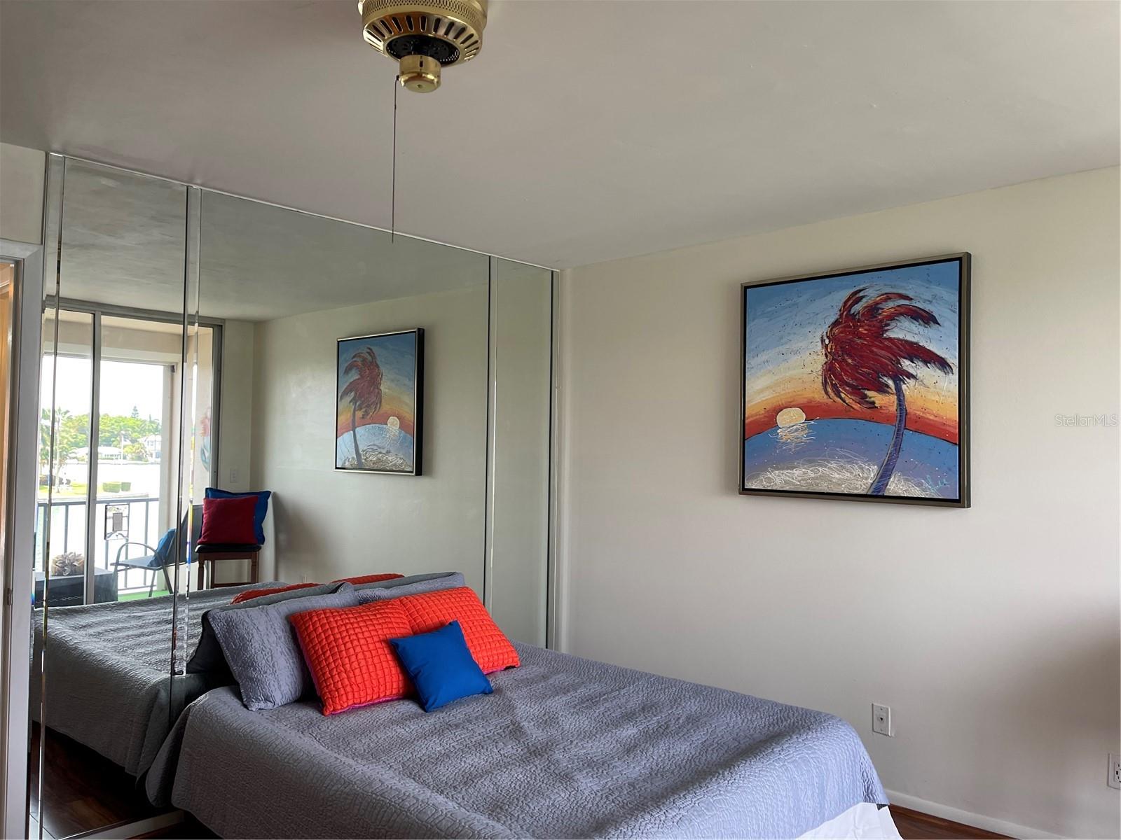 Mirrored accent wall in bedroom faces East and the intercoastal.