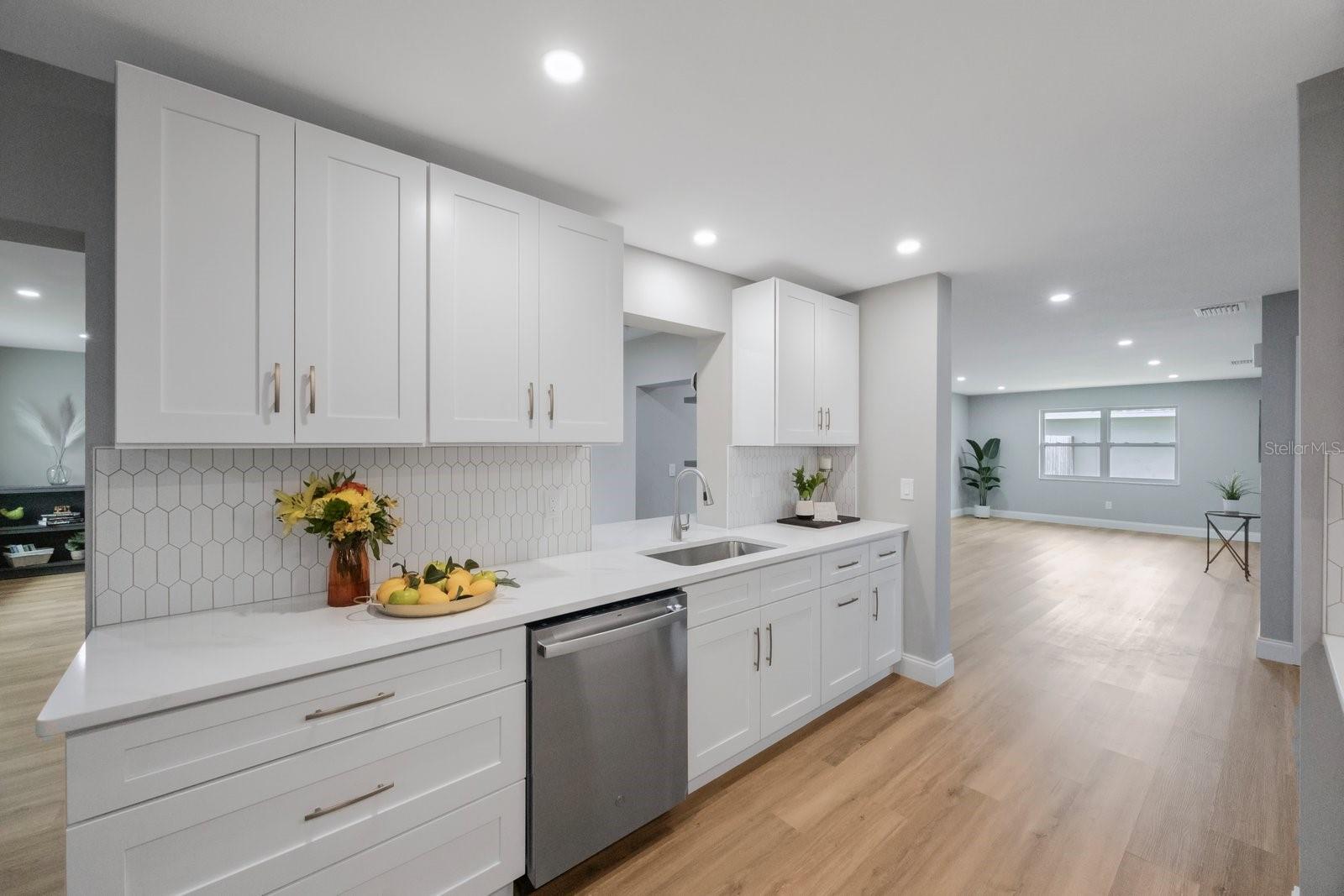 Picture perfect kitchen! Light and bright with wood cabinets, quartz countertops, and large single basin sink! A chefs dream! Plenty of counter space and cabinets!