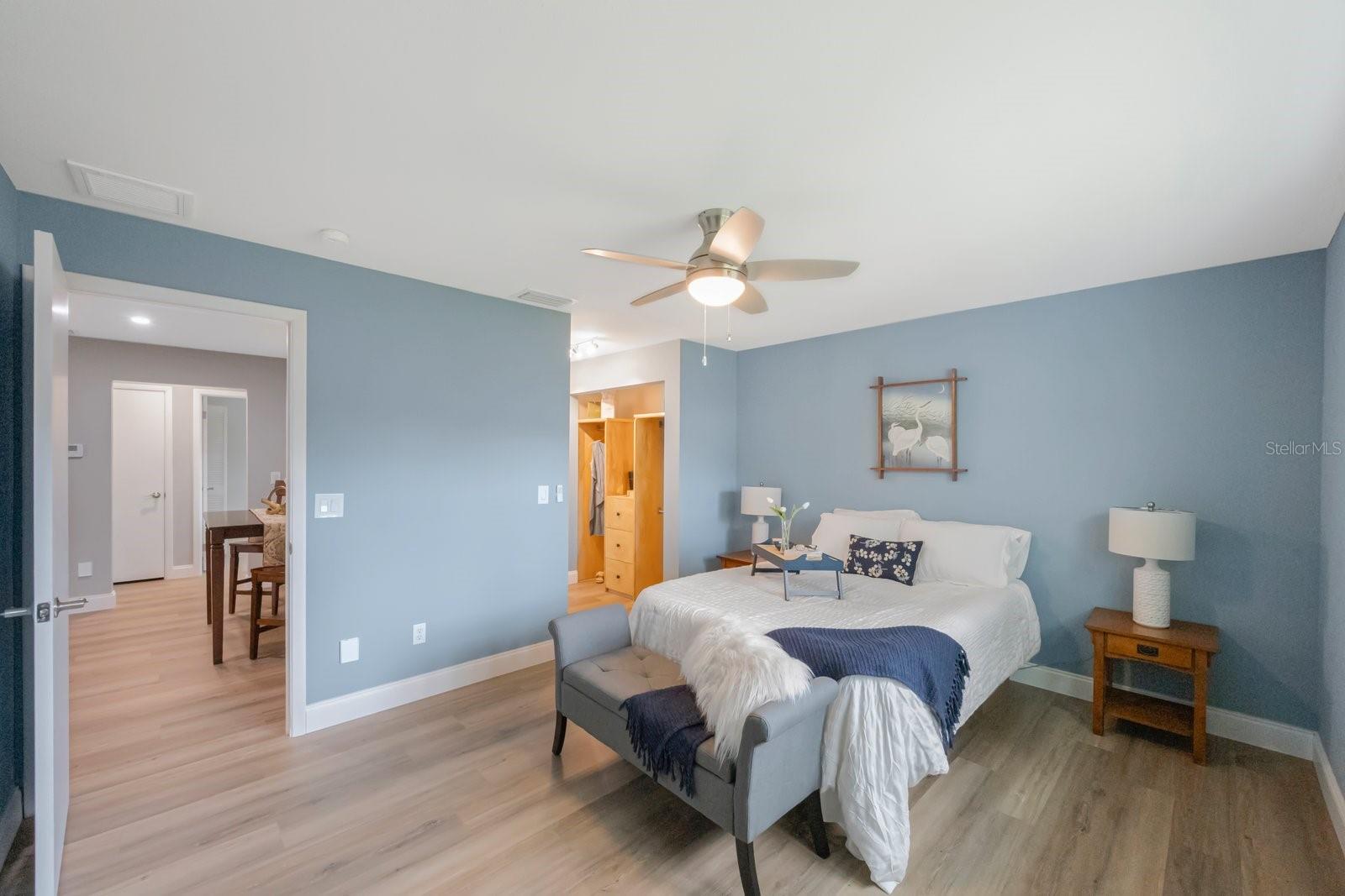 Spacous primary bedroom with en suite bath and custom closets!