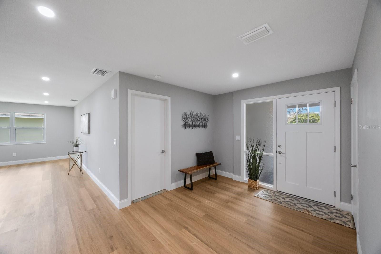 tremendous foyer with coat closet and room for table or bench!