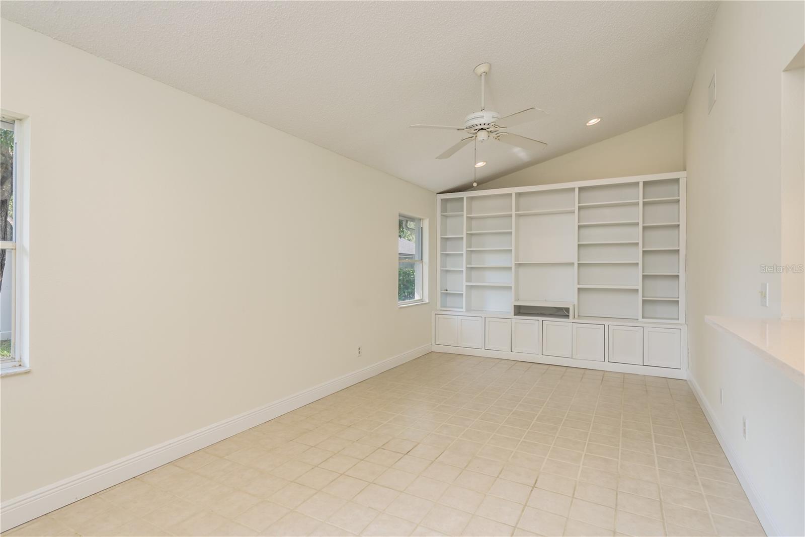 Family room with vaulted ceilings and built-in bookshelves