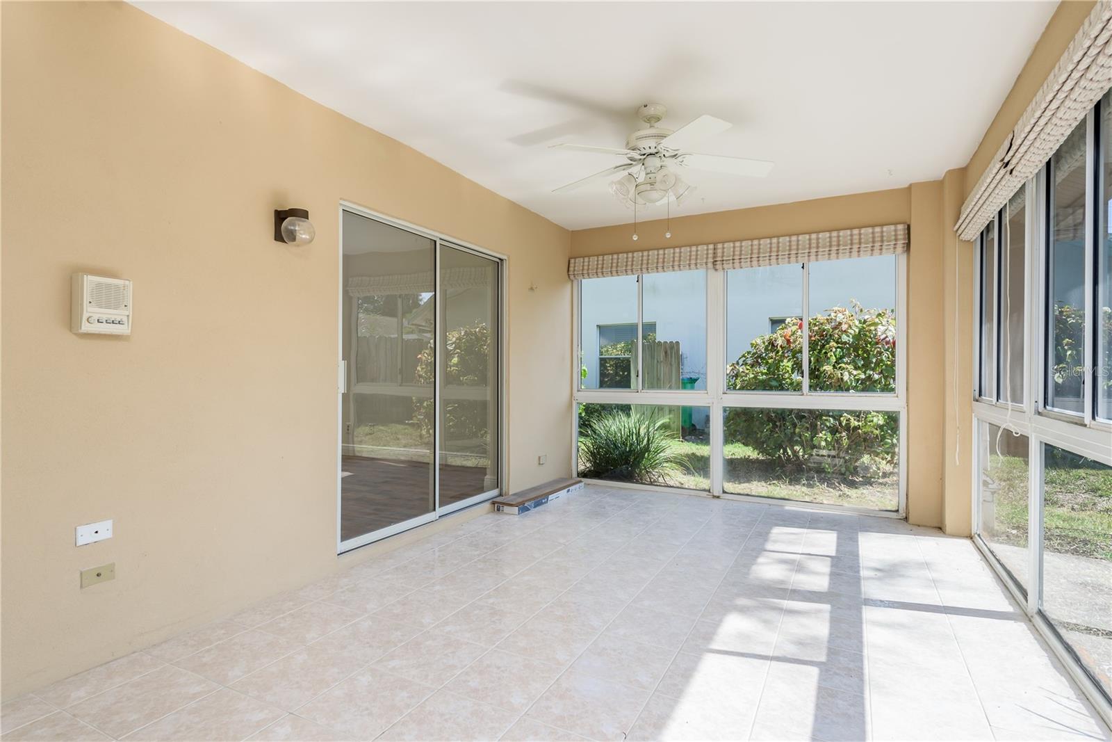 Florida room with sliding doors to primary bedroom