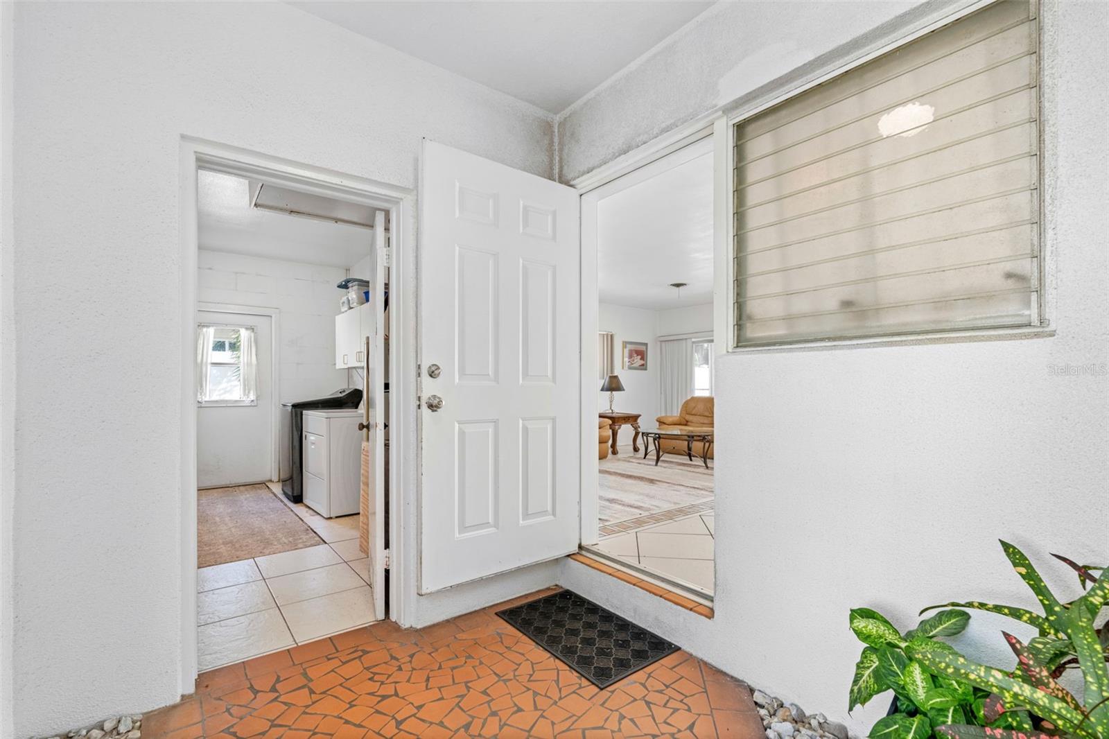 Covered front porch opens to home and laundry room.