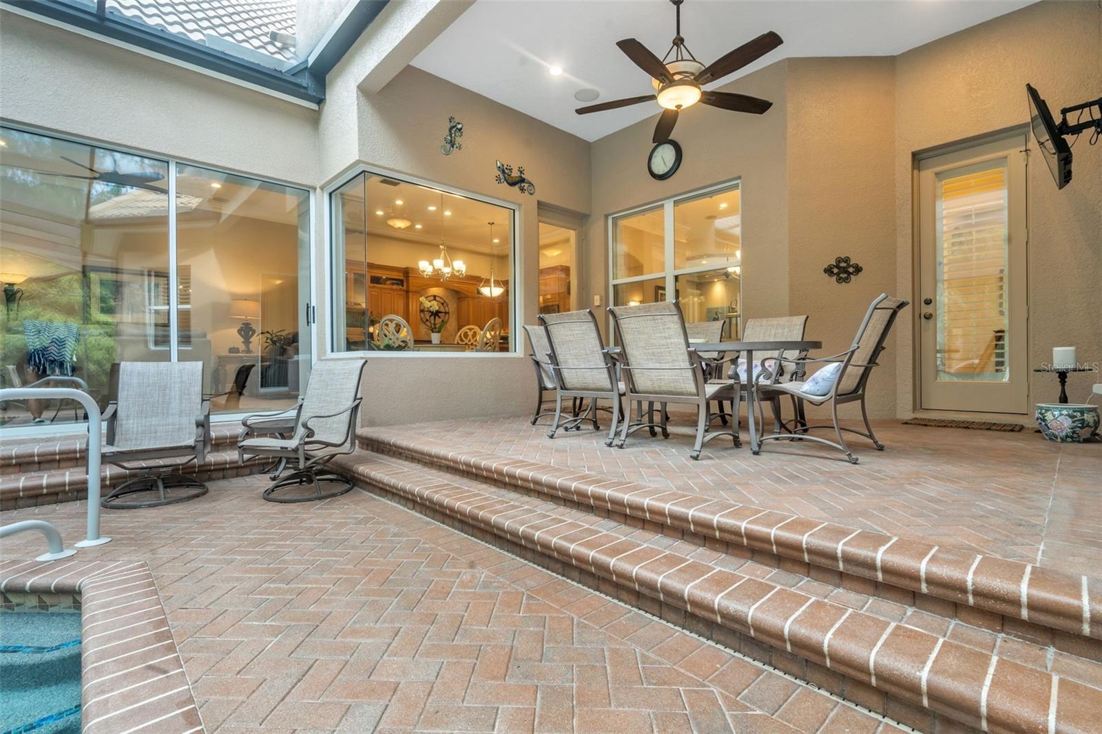 Covered outdoor area w/ ceiling fan & wall mounted TV