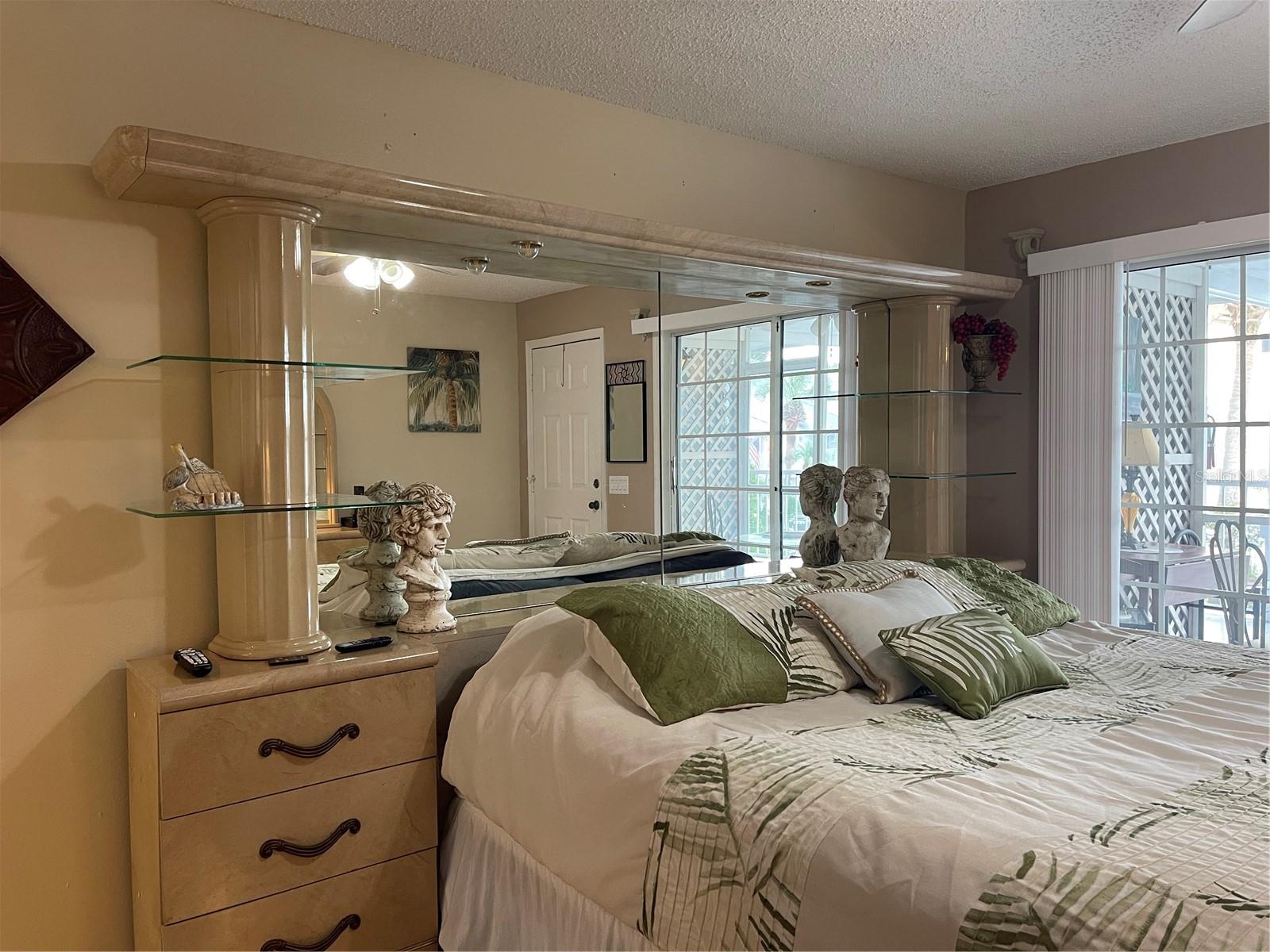 Bedroom furniture with drawers, shelving, column and light bridge will stay with the condo