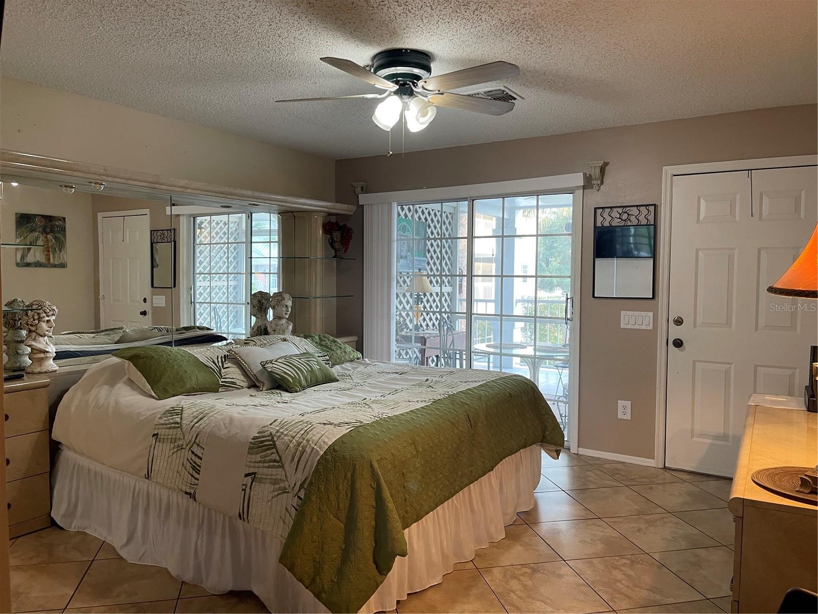 Sliding glass doors lead out to screened porch that overlooks the pond and pickle ball courts