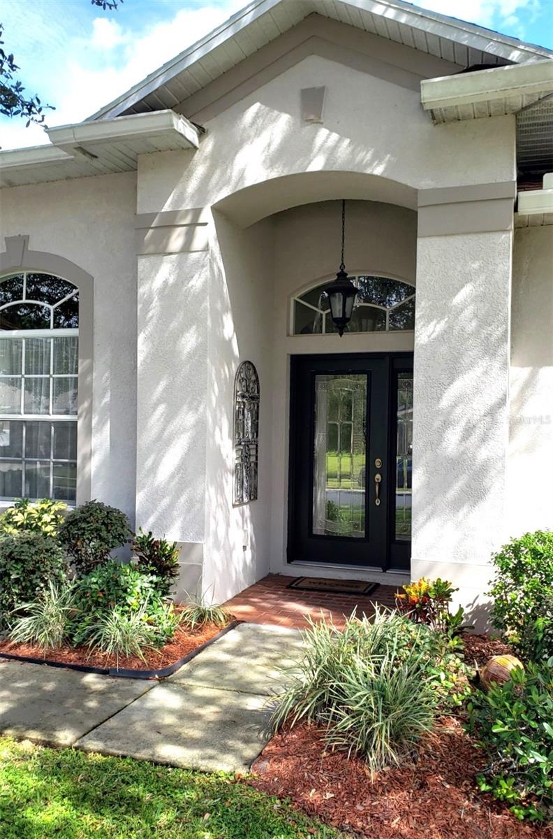 Covered Front Entry with Upgraded, Leaded Glass Door & Overhead Light