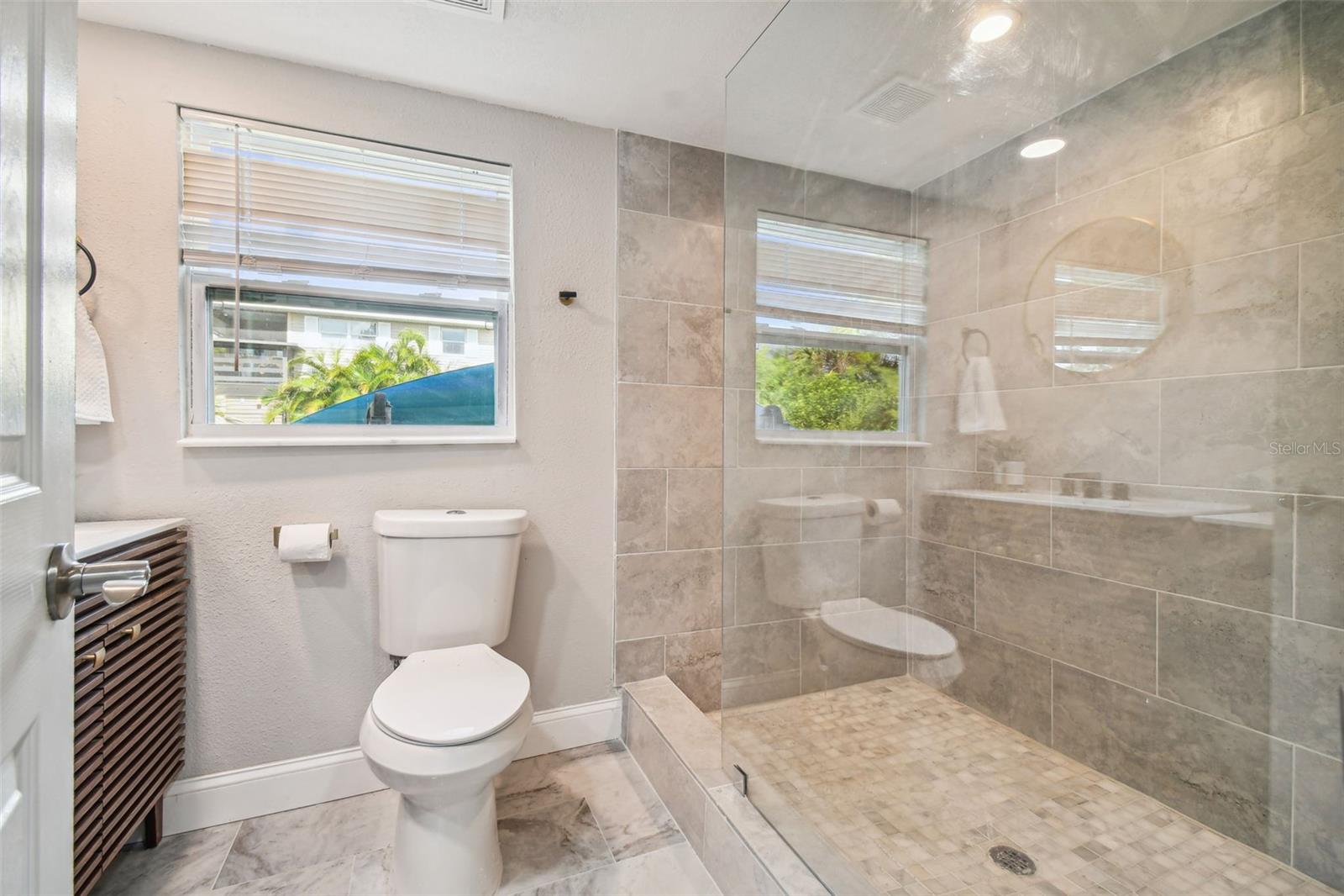 this gorgeous shower is HUGE and so spa-like -check out the beautiful new floors