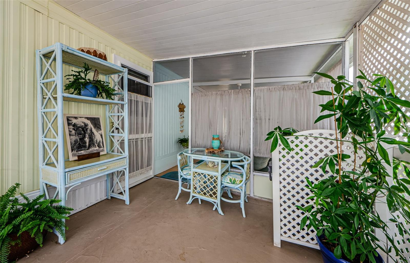 As you walk up the driveway and entry to the covered screened porch