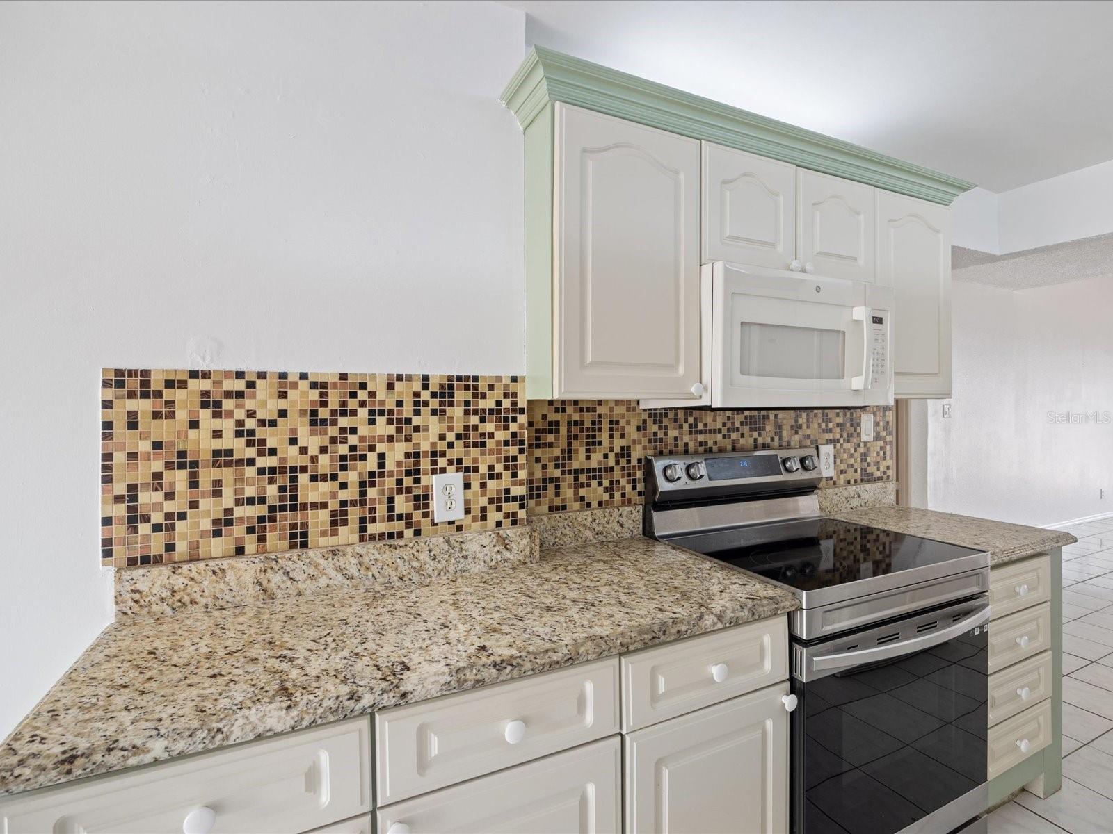 Granite countertops w/ tile backsplash