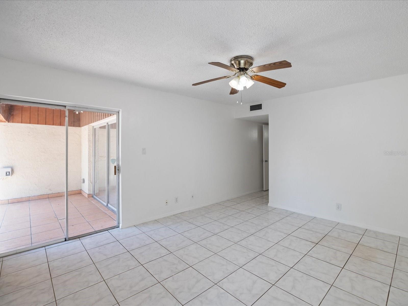 First floor master bedroom w/ sliding glass doors to back patio